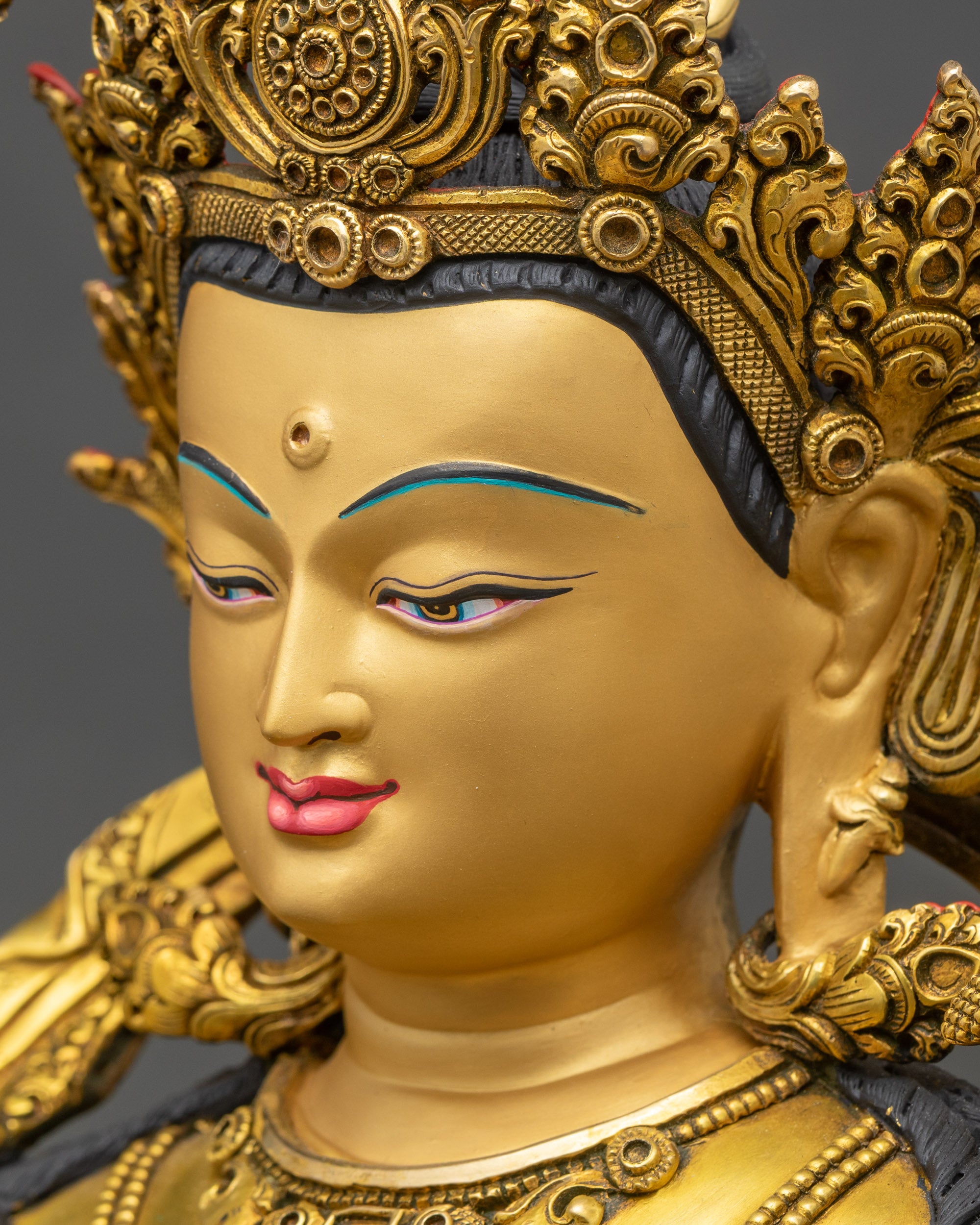 Detailed side close-up of Manjushri statue, intricate robe carvings visible