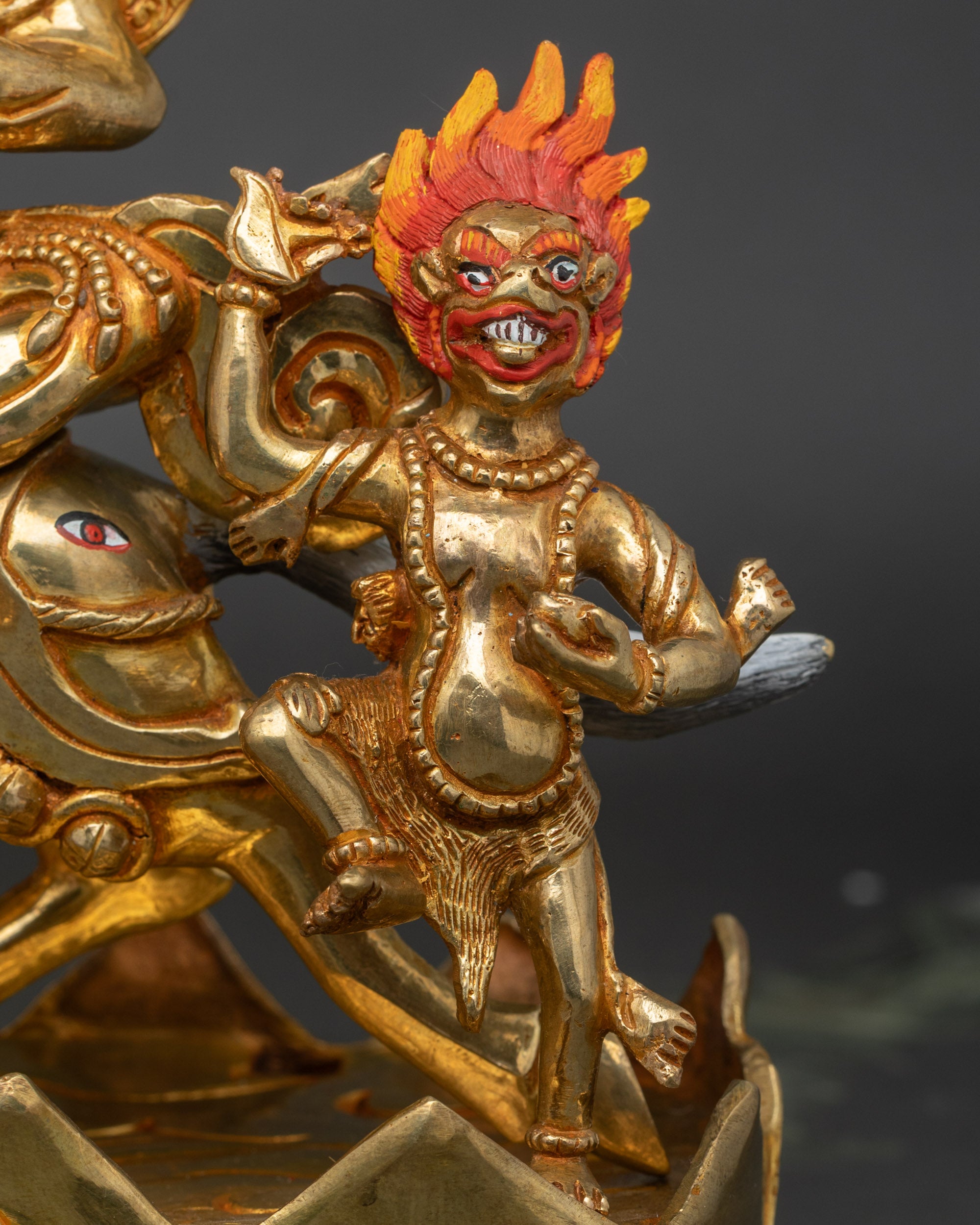 Detailed side close-up of Palden Lhamo face, fierce expression with wide eyes and bared teeth