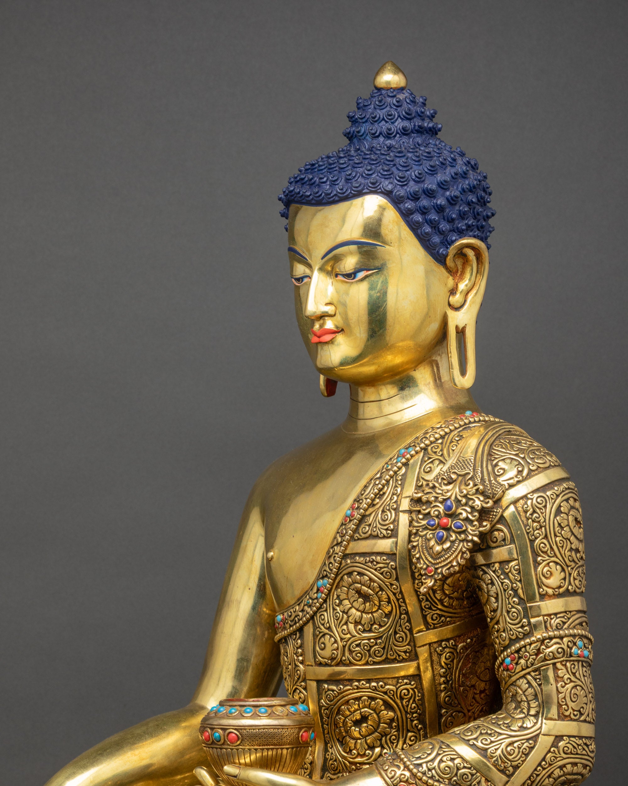 Detailed side close up Buddha Shakyamuni Statue highlighting carved robe folds and lotus seat
