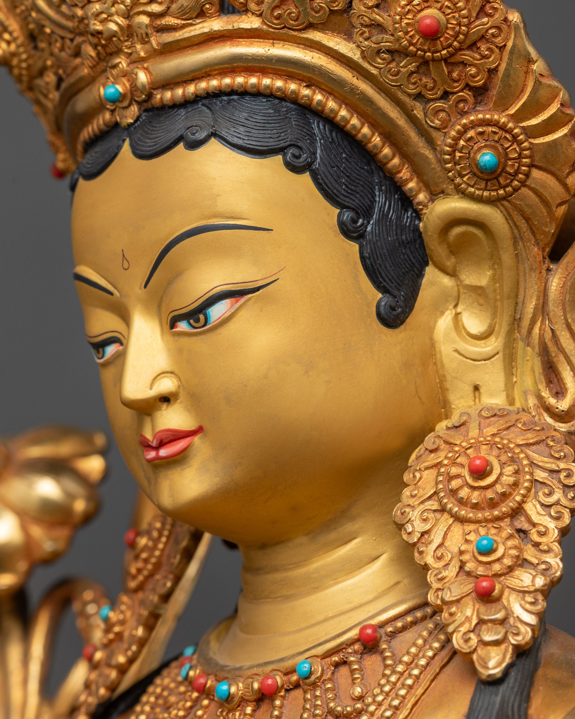 Detailed side close up Green Tara statue jewelry armlets flowing robe lotus pedestal