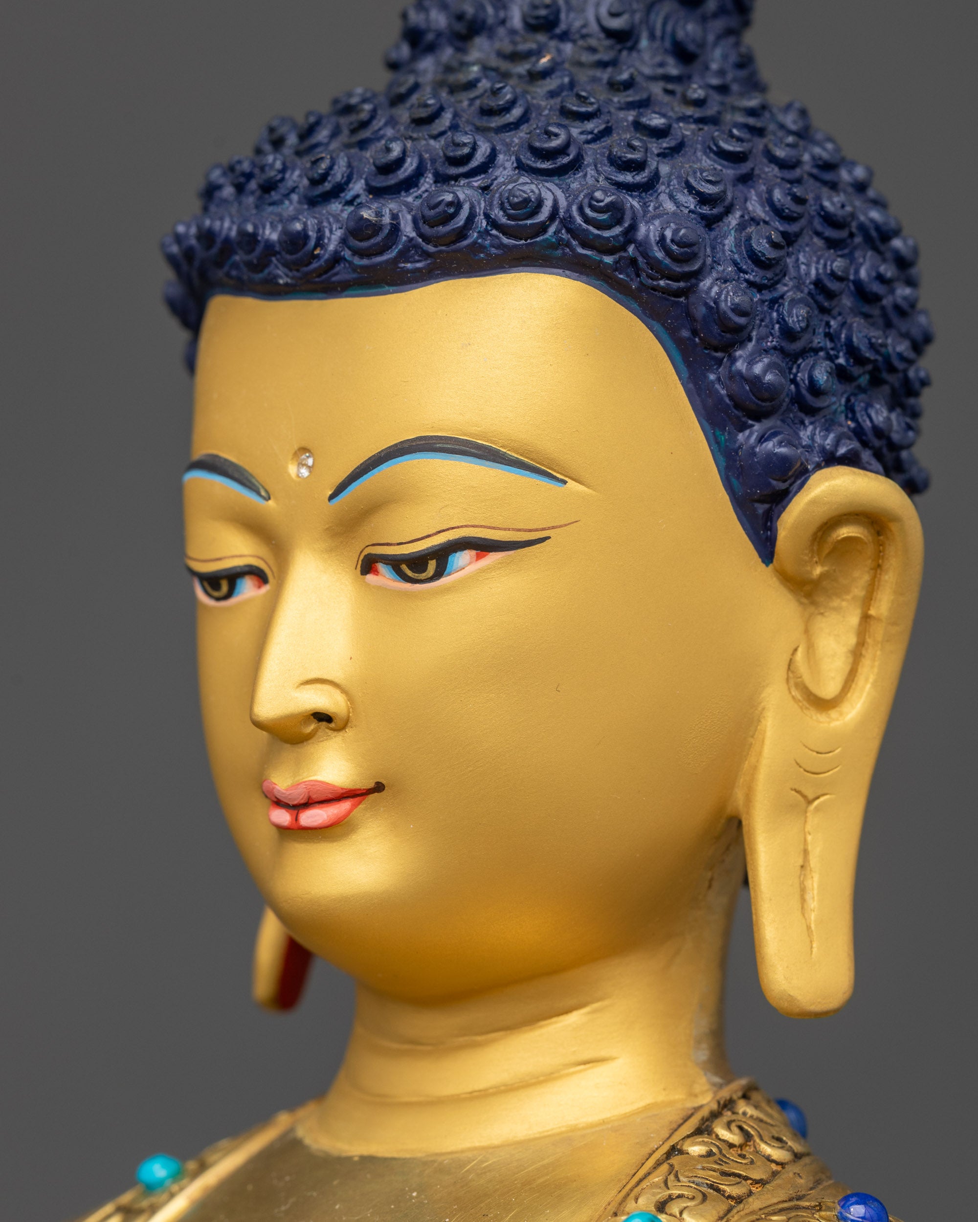Detailed side close up face Amitabha Buddha gold-gilded copper calm serene face