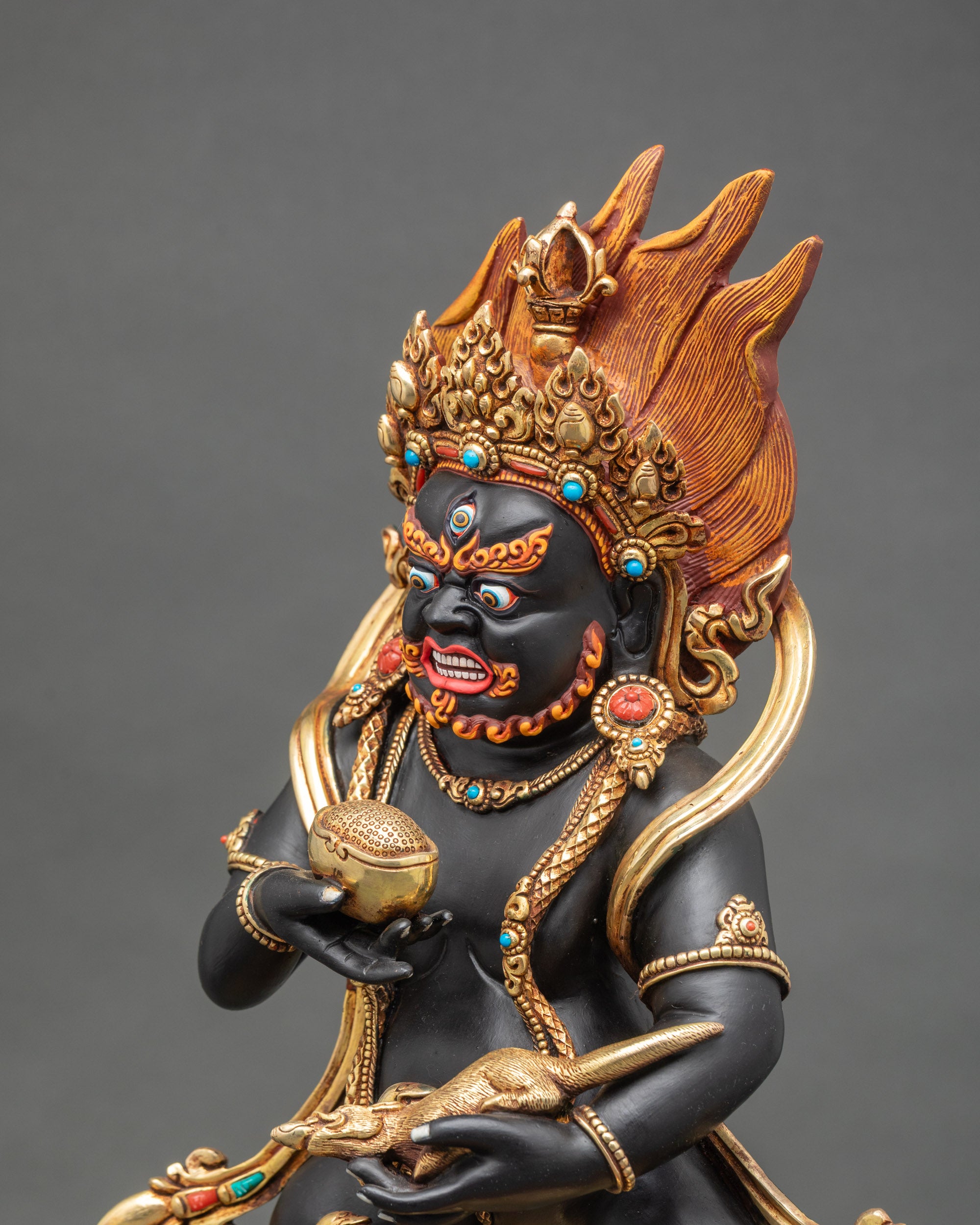 Detailed side close up face – Close-up side view of Black Dzambhala face with turquoise and coral inlays