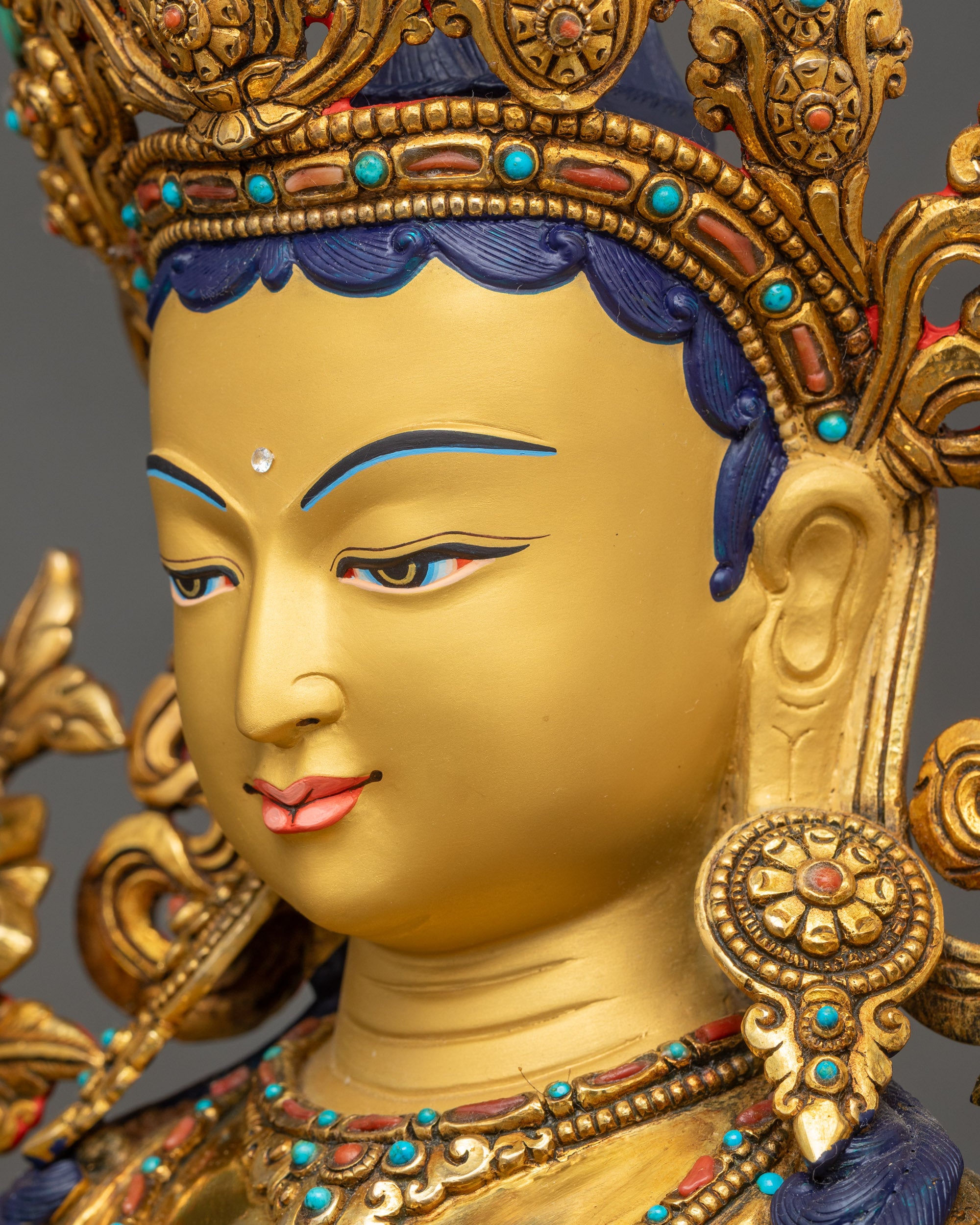 Detailed side close up face Green Tara Bodhisattva side view gold-gilded serene face and crown
