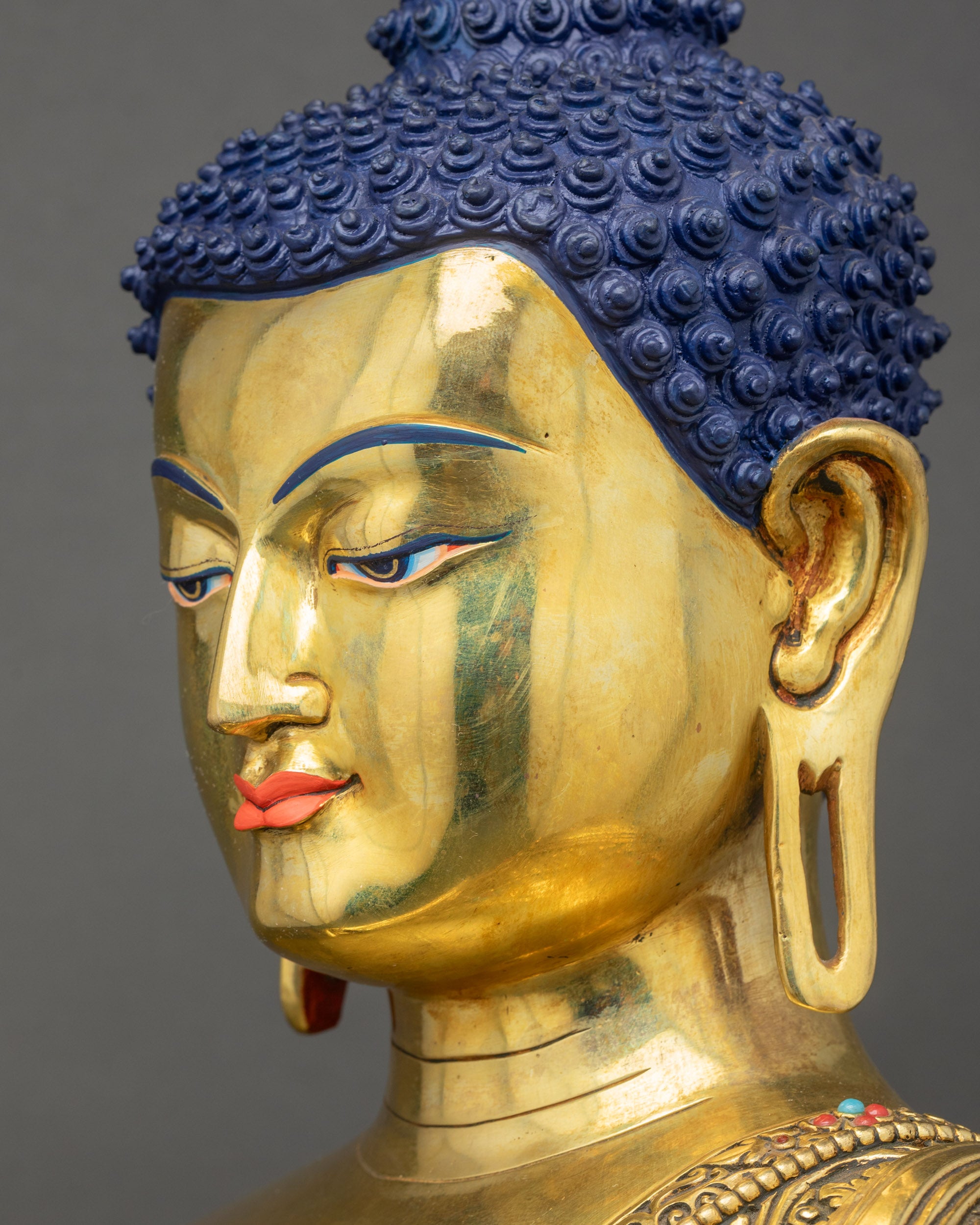 Detailed side close up face of Buddha Shakyamuni Statue showing peaceful expression and halo
