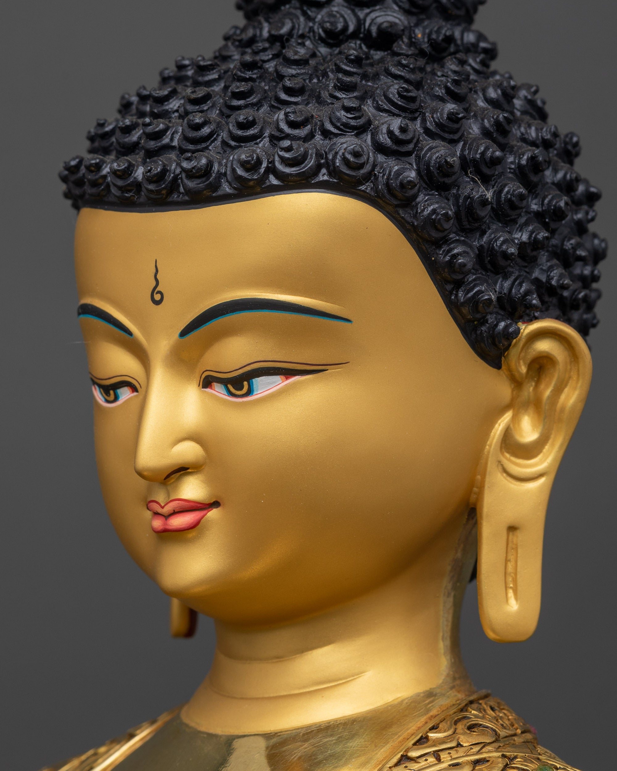 Detailed side close up face of Medicine Buddha highlighting compassionate expression