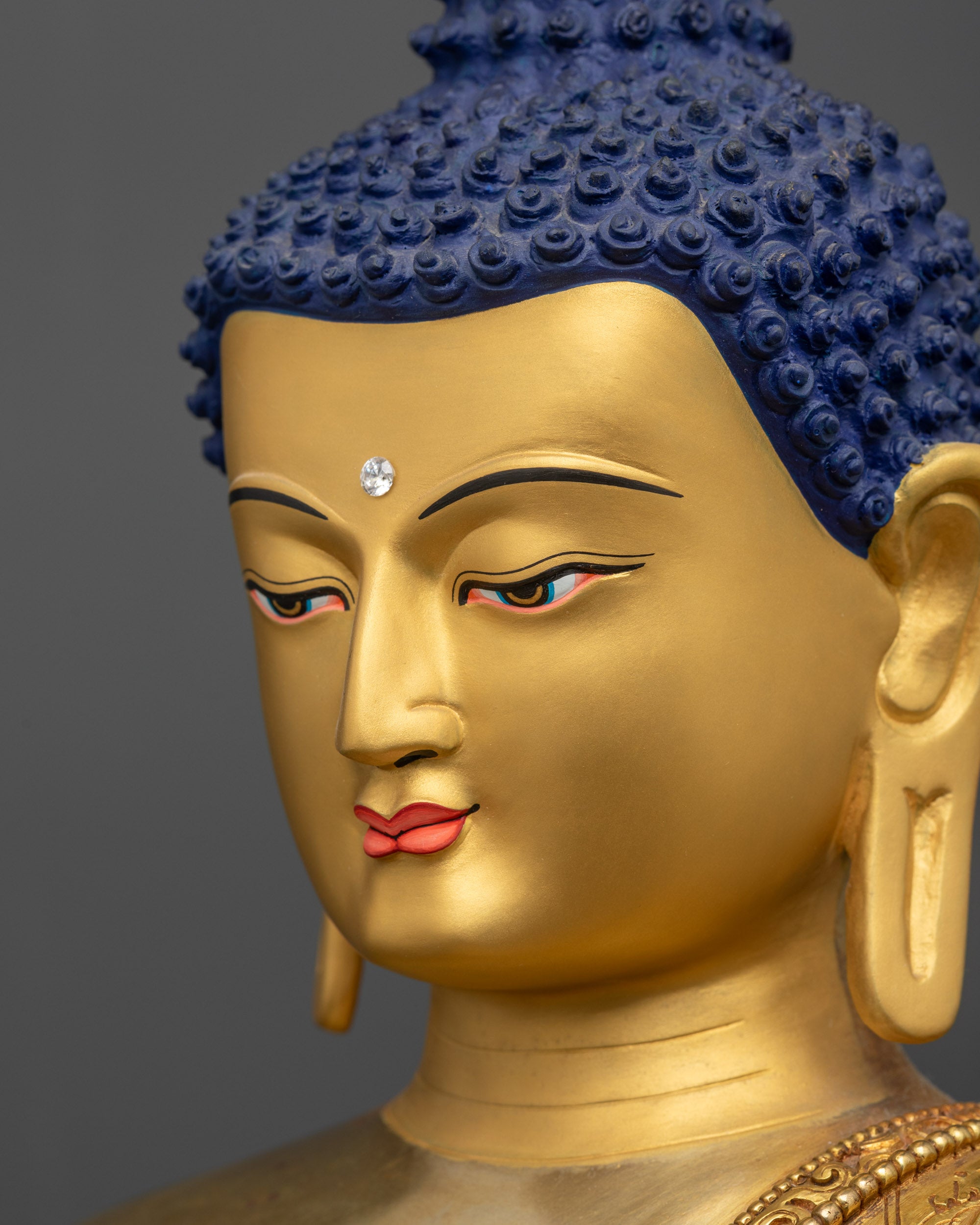 Detailed side close up face of Shakyamuni Buddha highlighting gold-gilded expression