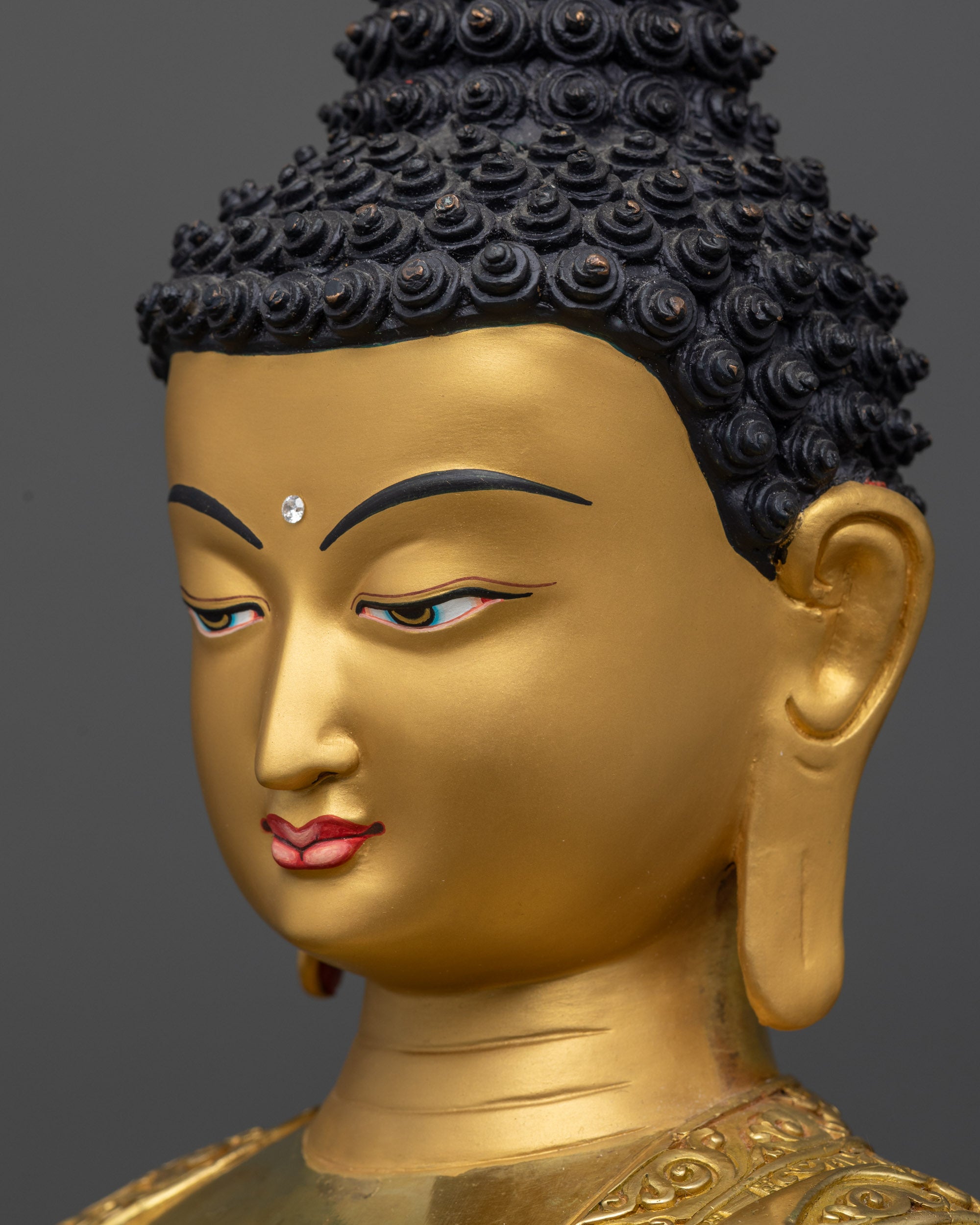 Detailed side close up of Buddha Mitrugpa statue showing Gold-Gilded Face