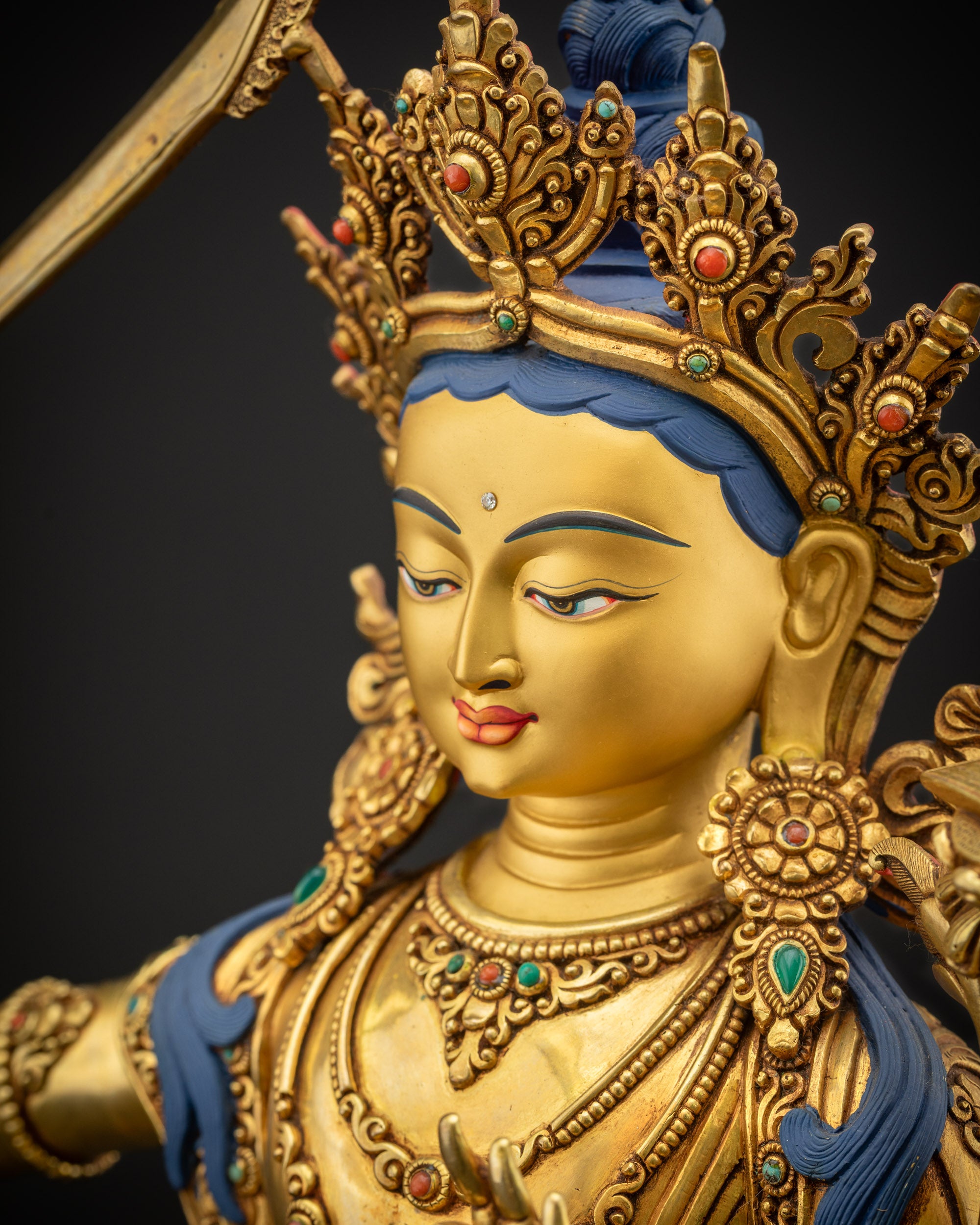 Detailed side close up of Manjushri Bodhisattva showing armlets and jewelry