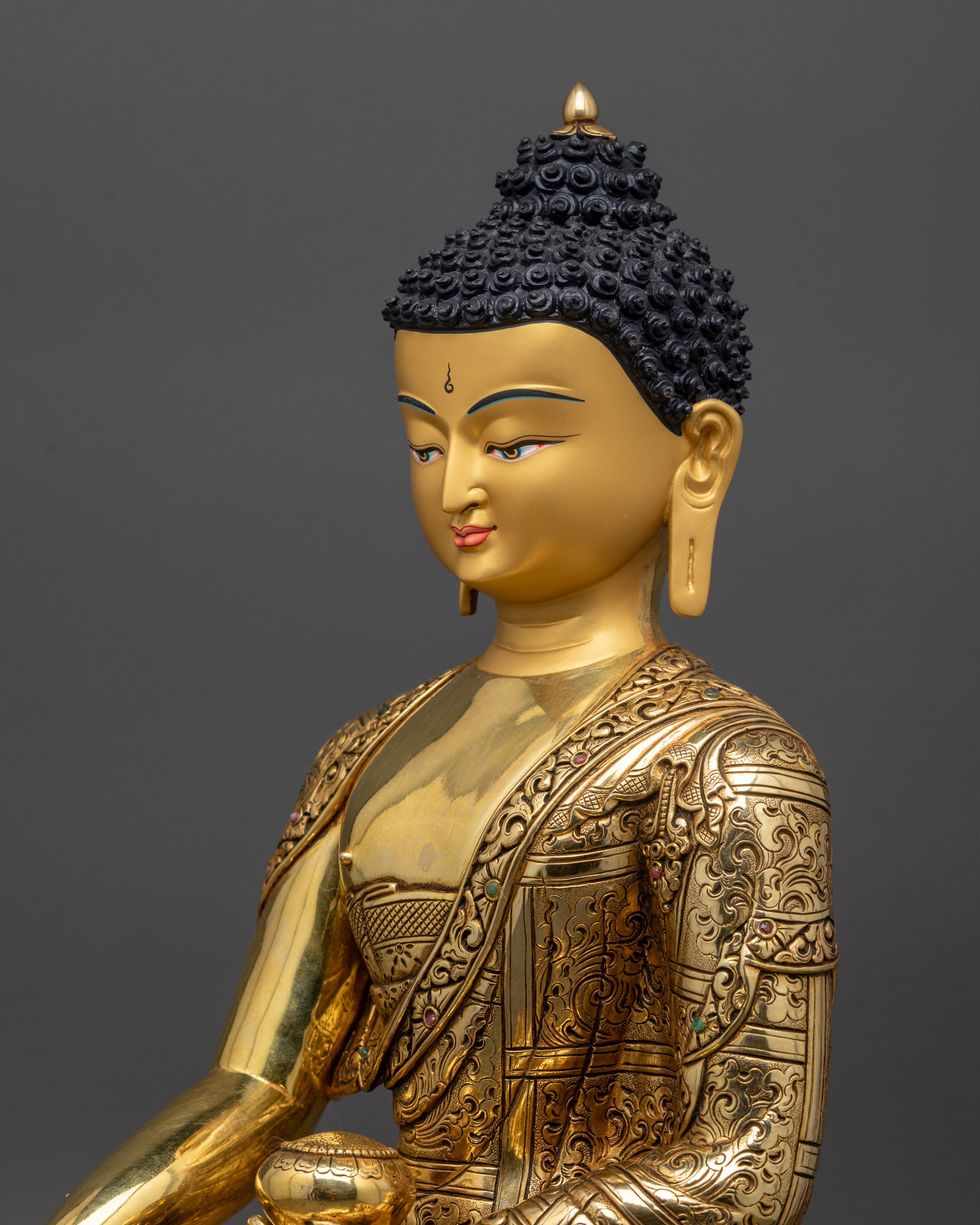 Detailed side close up of Shakyamuni Buddha showing carved robe patterns and halo