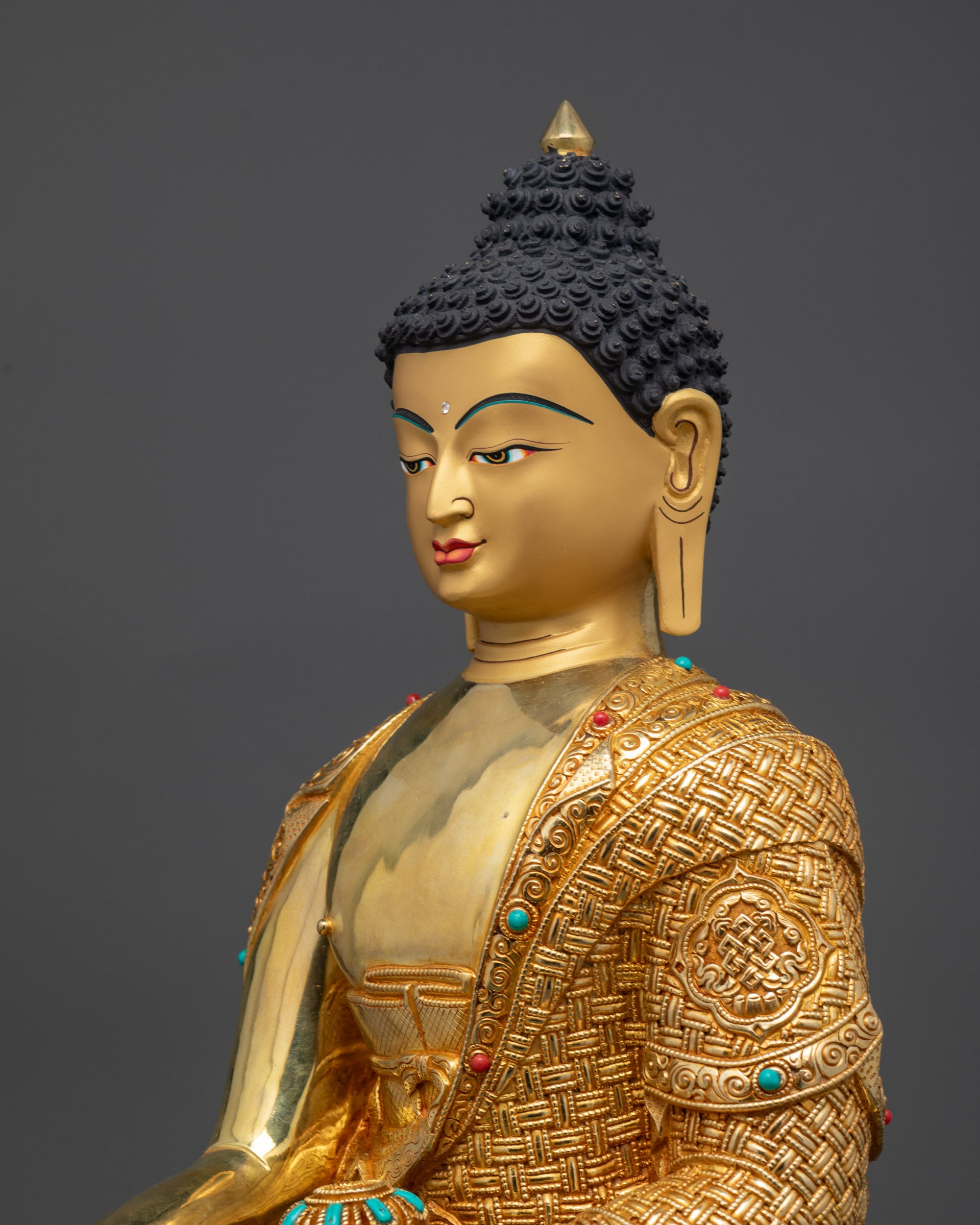 Detailed side close up of Shakyamuni Buddha statue highlighting robe and halo details