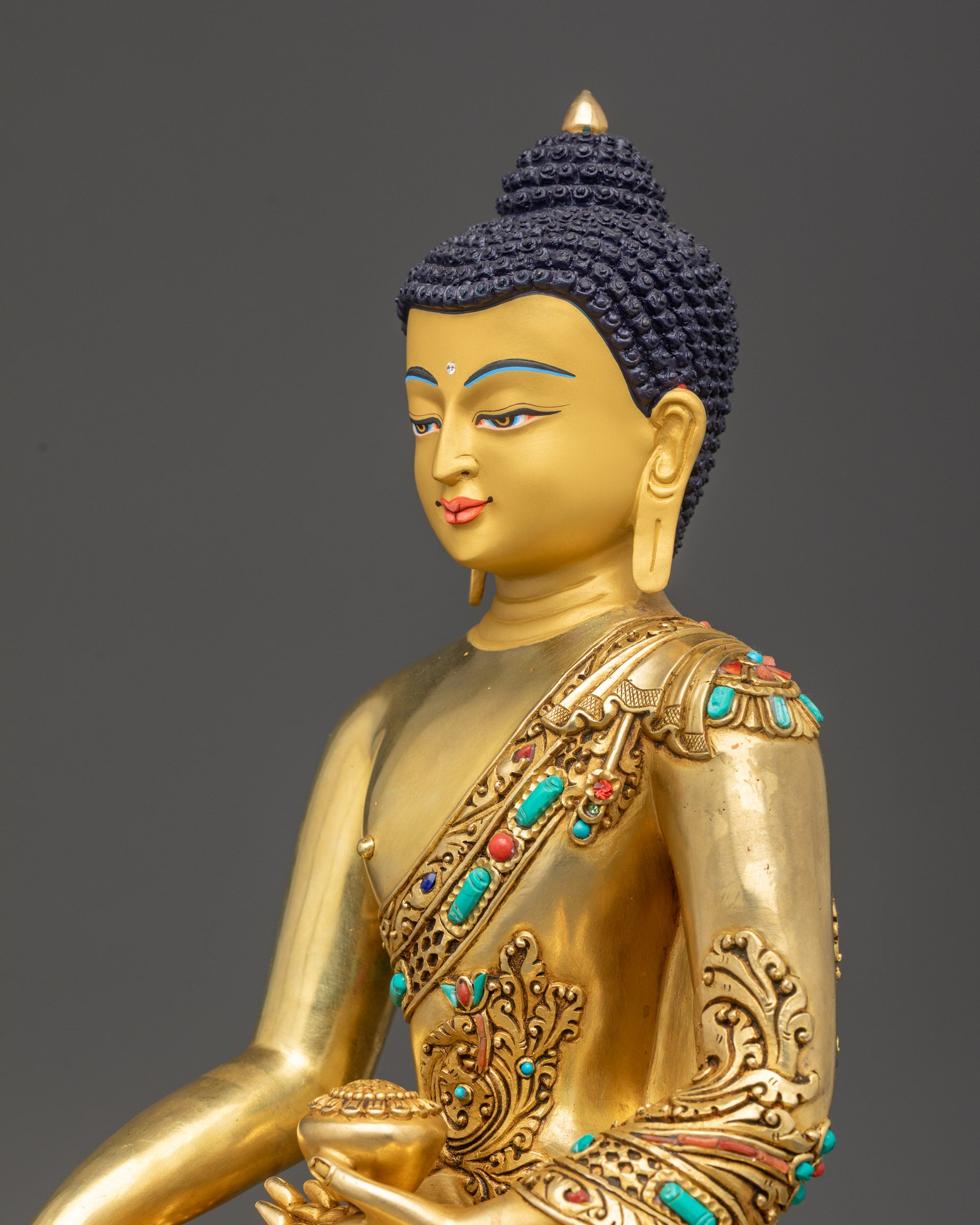 Detailed side close up of Shakyamuni Buddha statue showing carved feather floral robe design