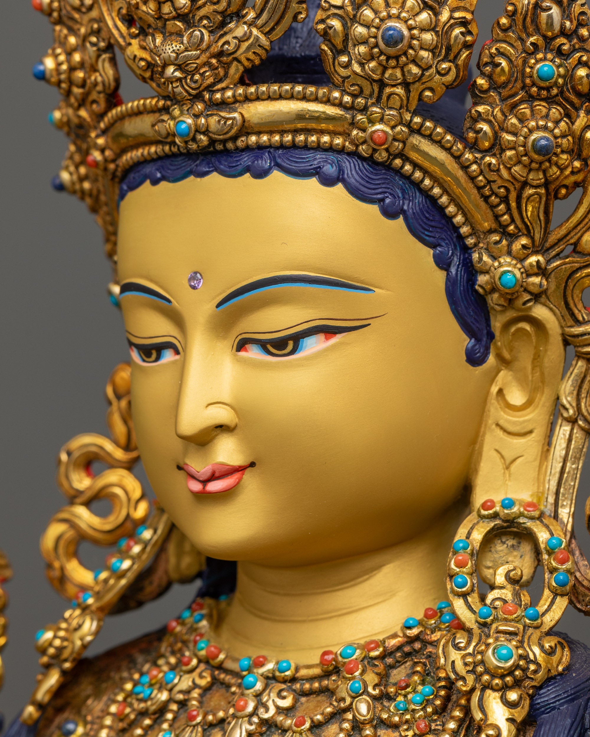 Detailed side close up of face Maitreya Buddha with semi-precious jeweled crown
