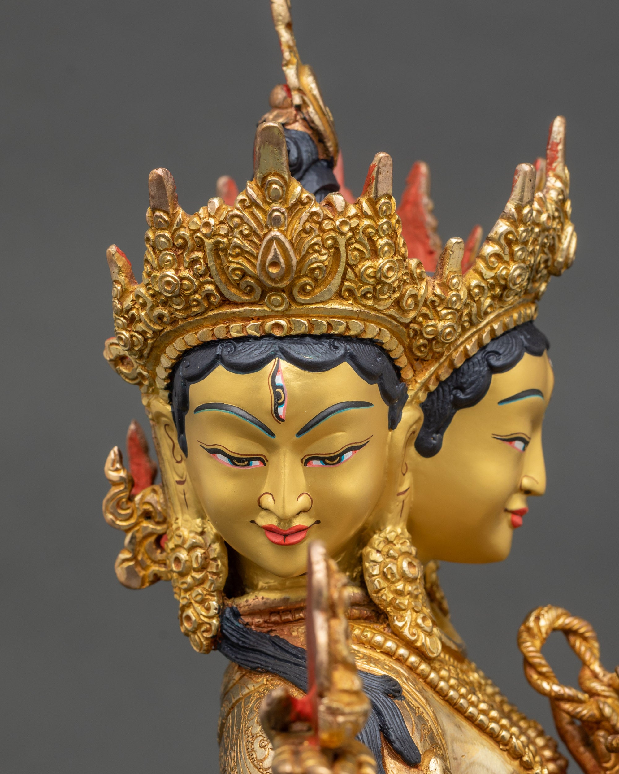 Detailed side face close up of Ushnishavijaya with crown details and calm gaze