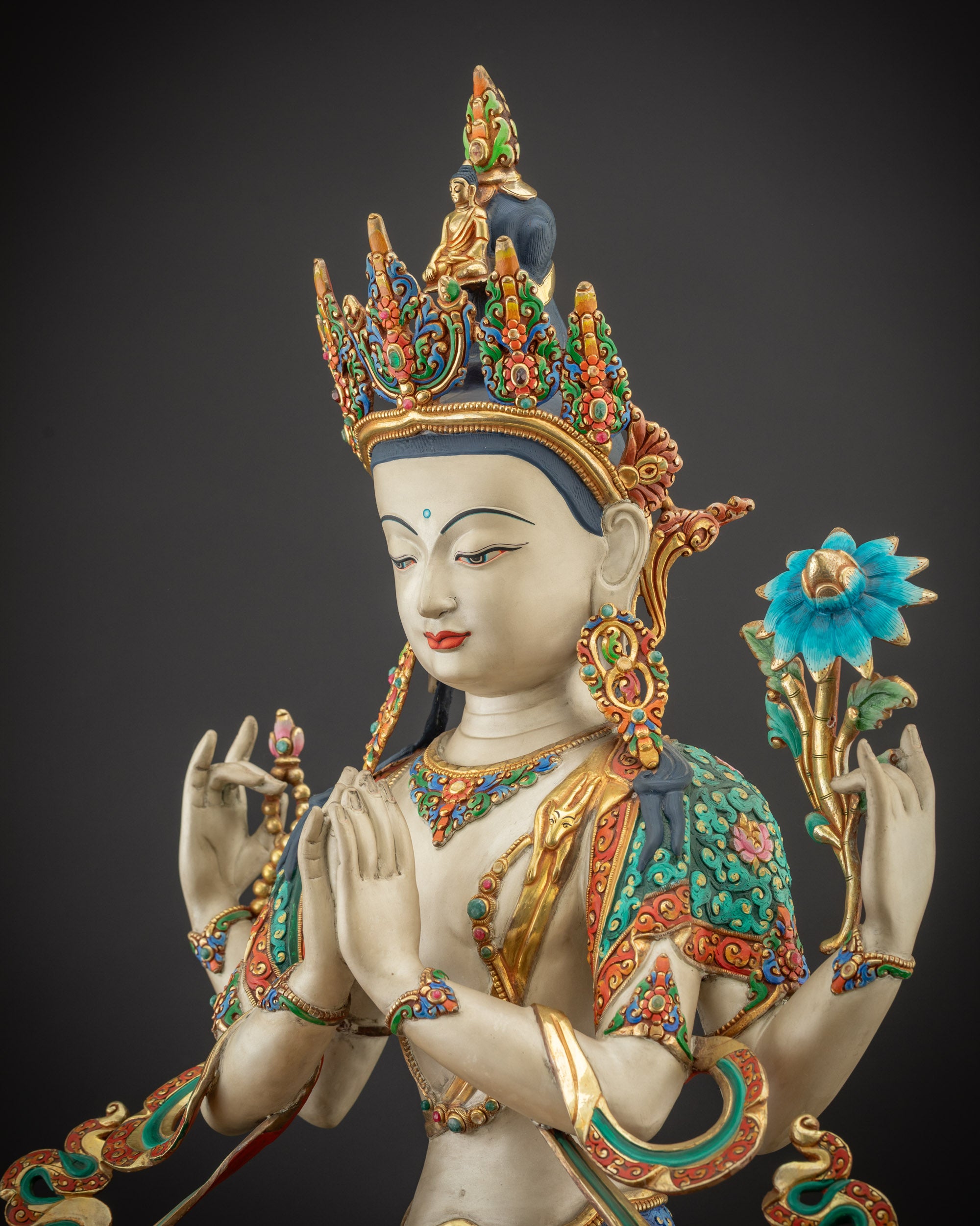 Detailed side view Chenrezig Statue showing gold-plated robes and lotus seat carvings