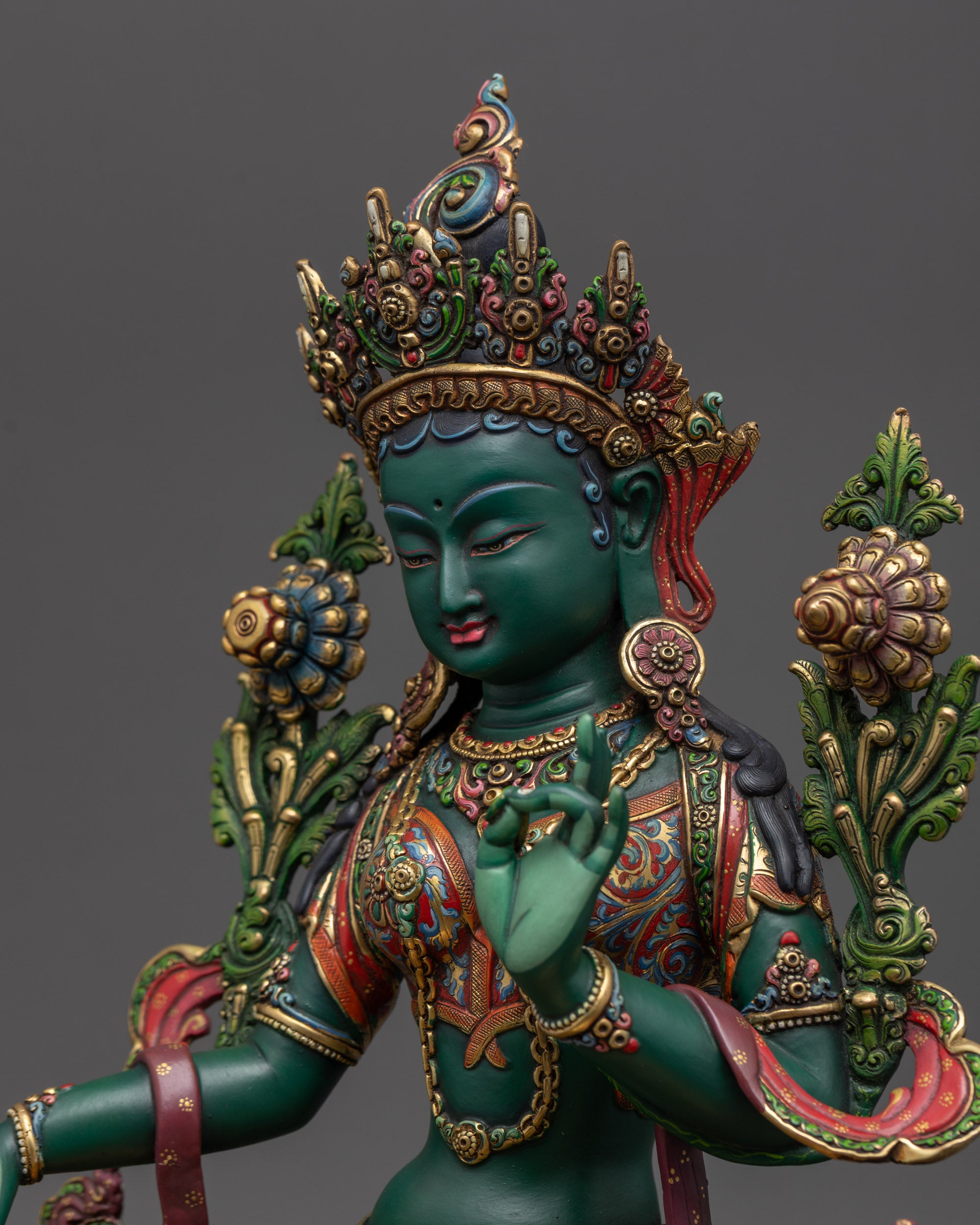 Detailed side view Green Tara statue showing Varada Mudra and Vitarka Mudra hand gestures
