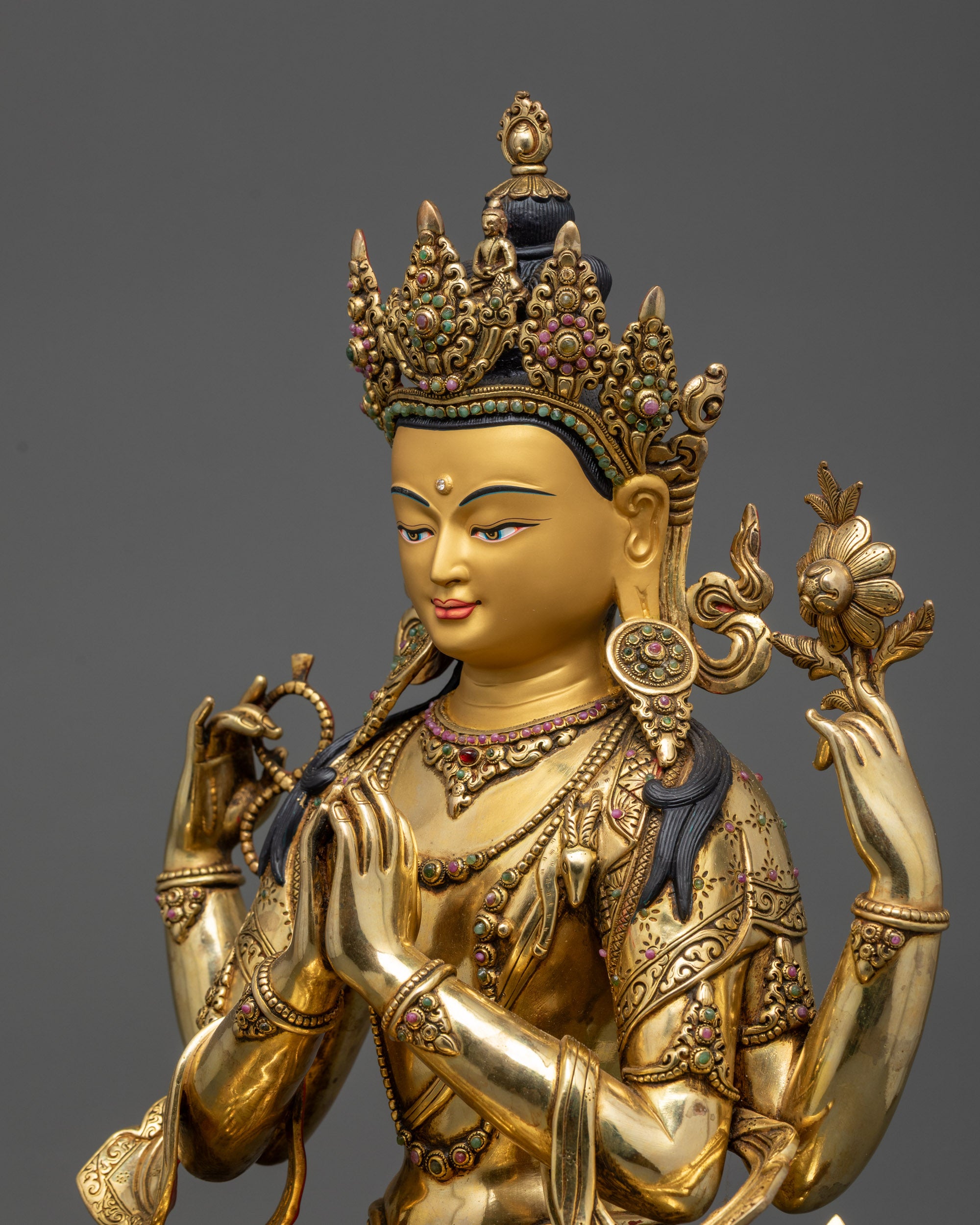 Detailed side view of Chenrezig statue showing intricate lotus throne and gold-gilded robe