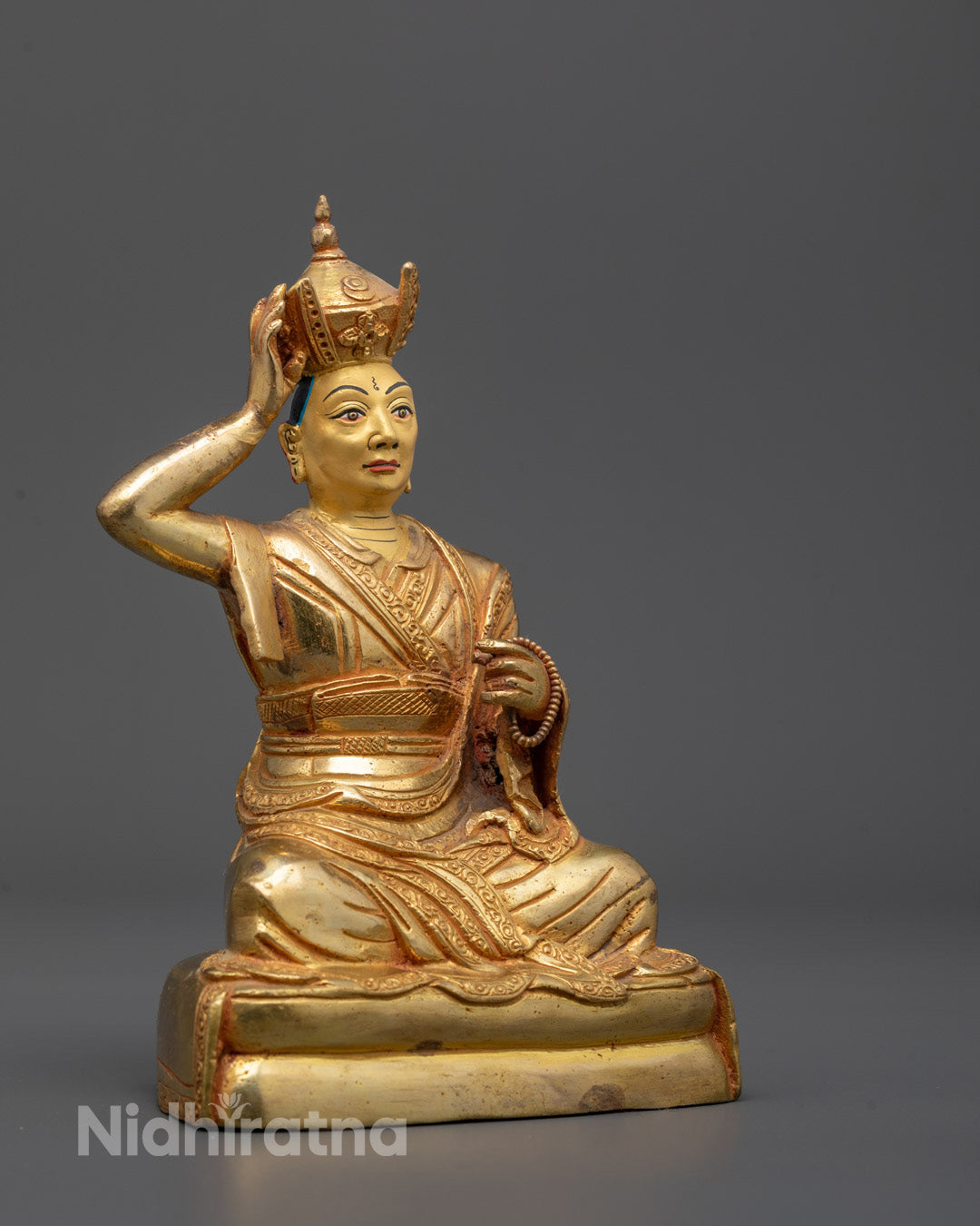 Detailed side view of Karmapa Statue showcasing intricate robe patterns