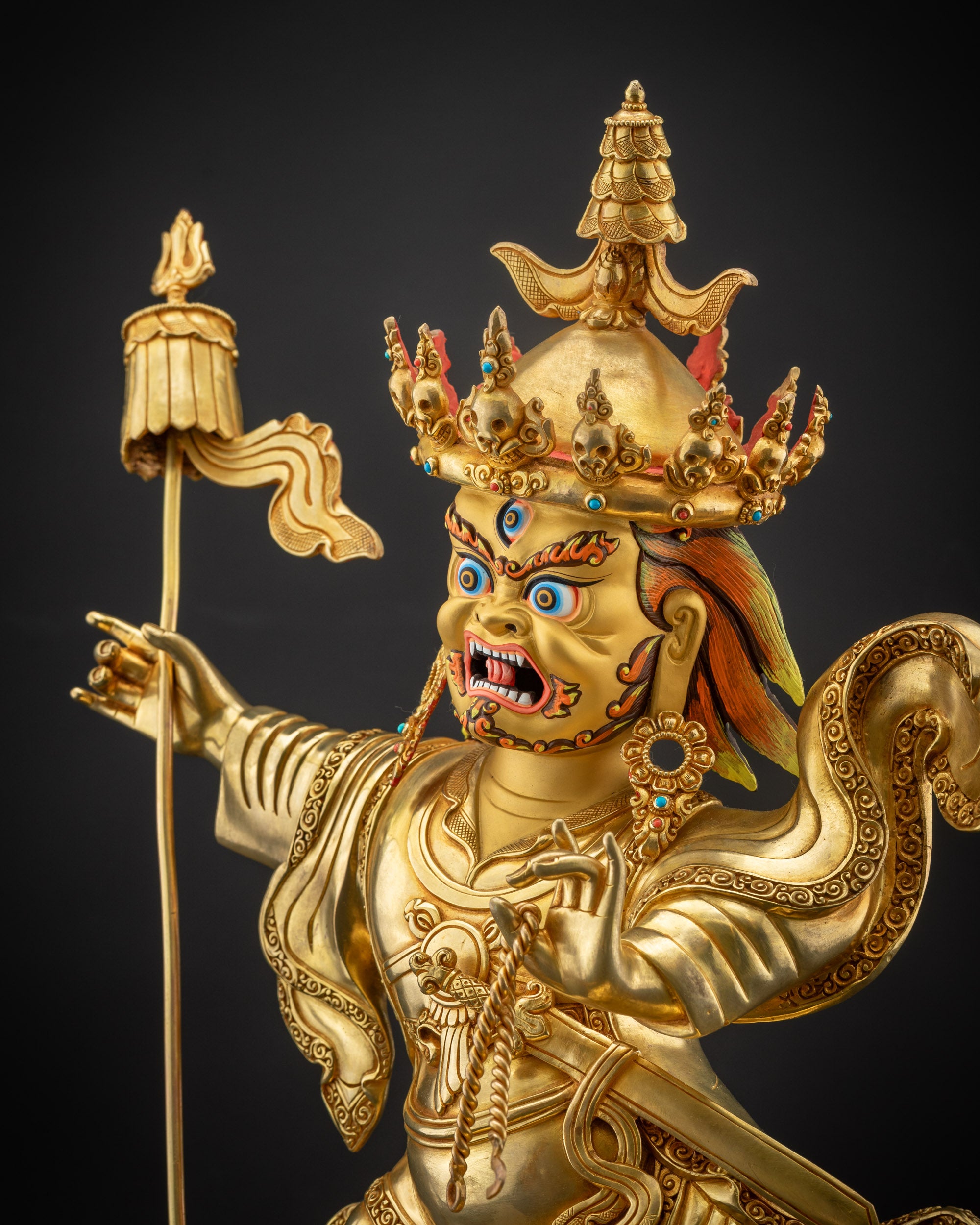 Detailed side view of Nechung Chuyong Statue highlighting gold fire-gilded body