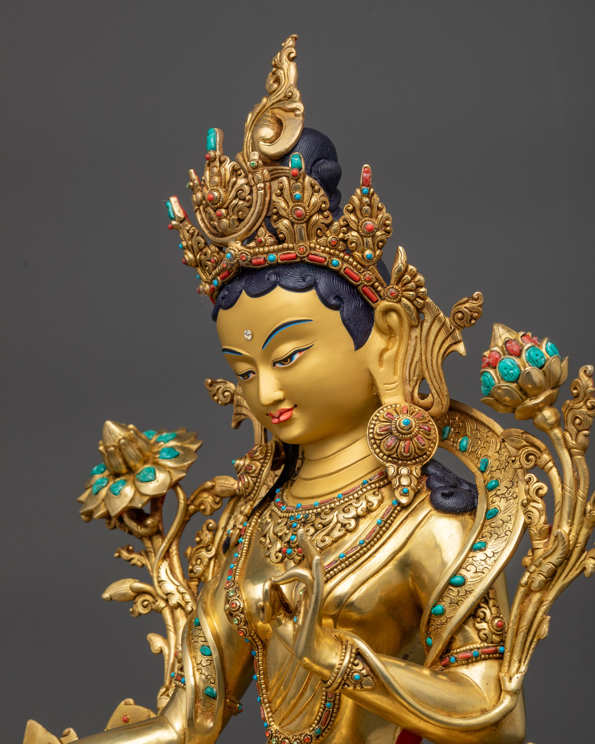 Detailed side view of Premium Green Tara highlighting swirling robes and lotus seat