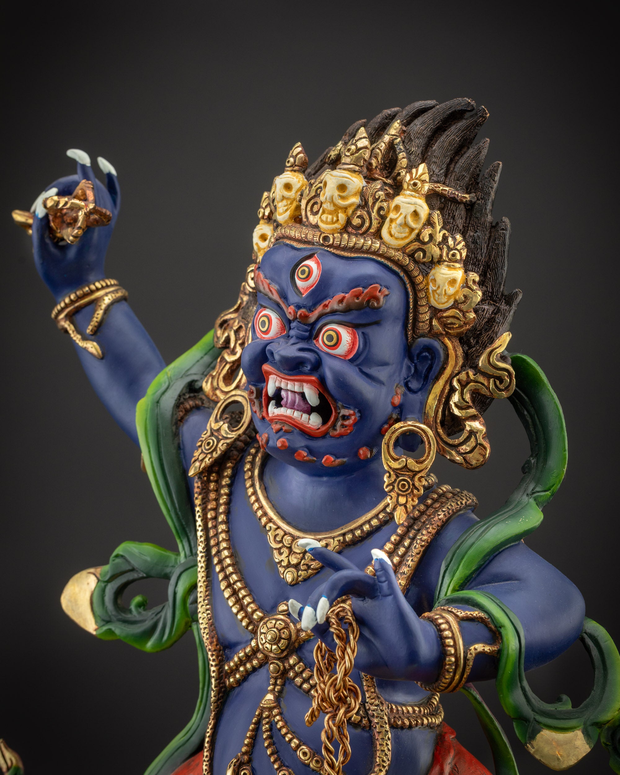 Detailed side view of Vajrapani statue showing serpent, robe, and lotus base