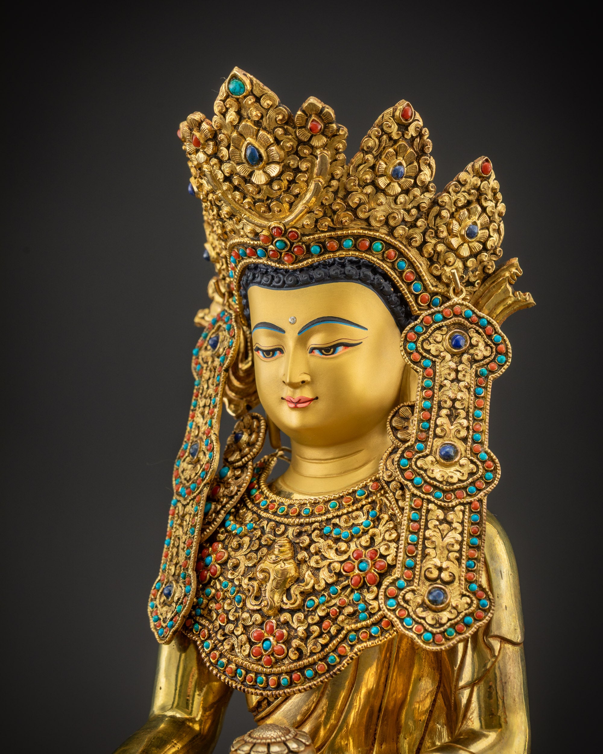 Detailed side view of sacred Jowo Rinpoche Buddha showing crown and robe