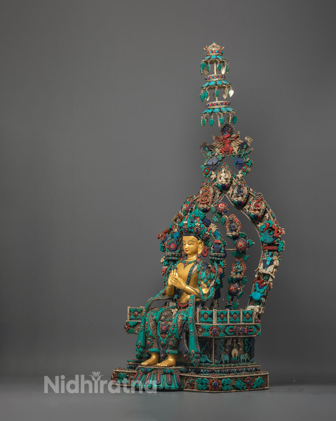 Maitreya Buddha's serene face and hands in wisdom mudra, featuring pure gold coating and turquoise accents