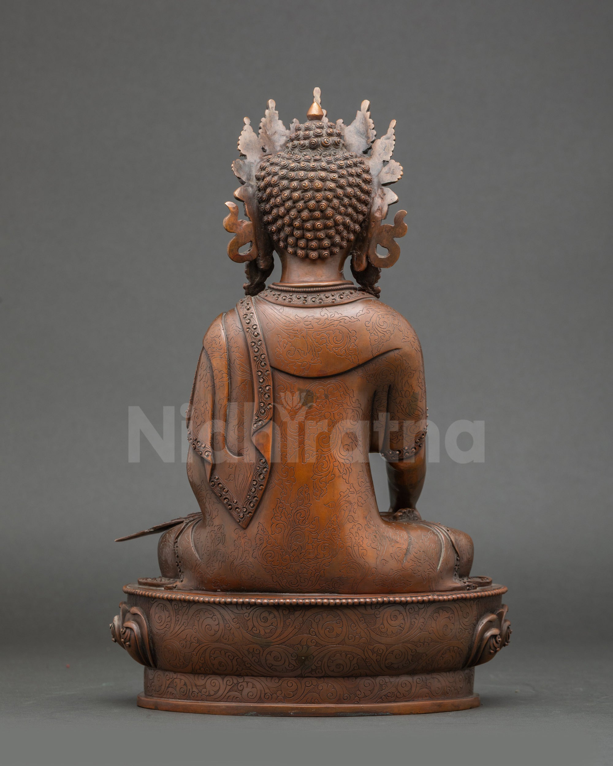 Detailed view of Mitrugpa Buddha holding Vajra, earth-touching mudra, oxidized finish