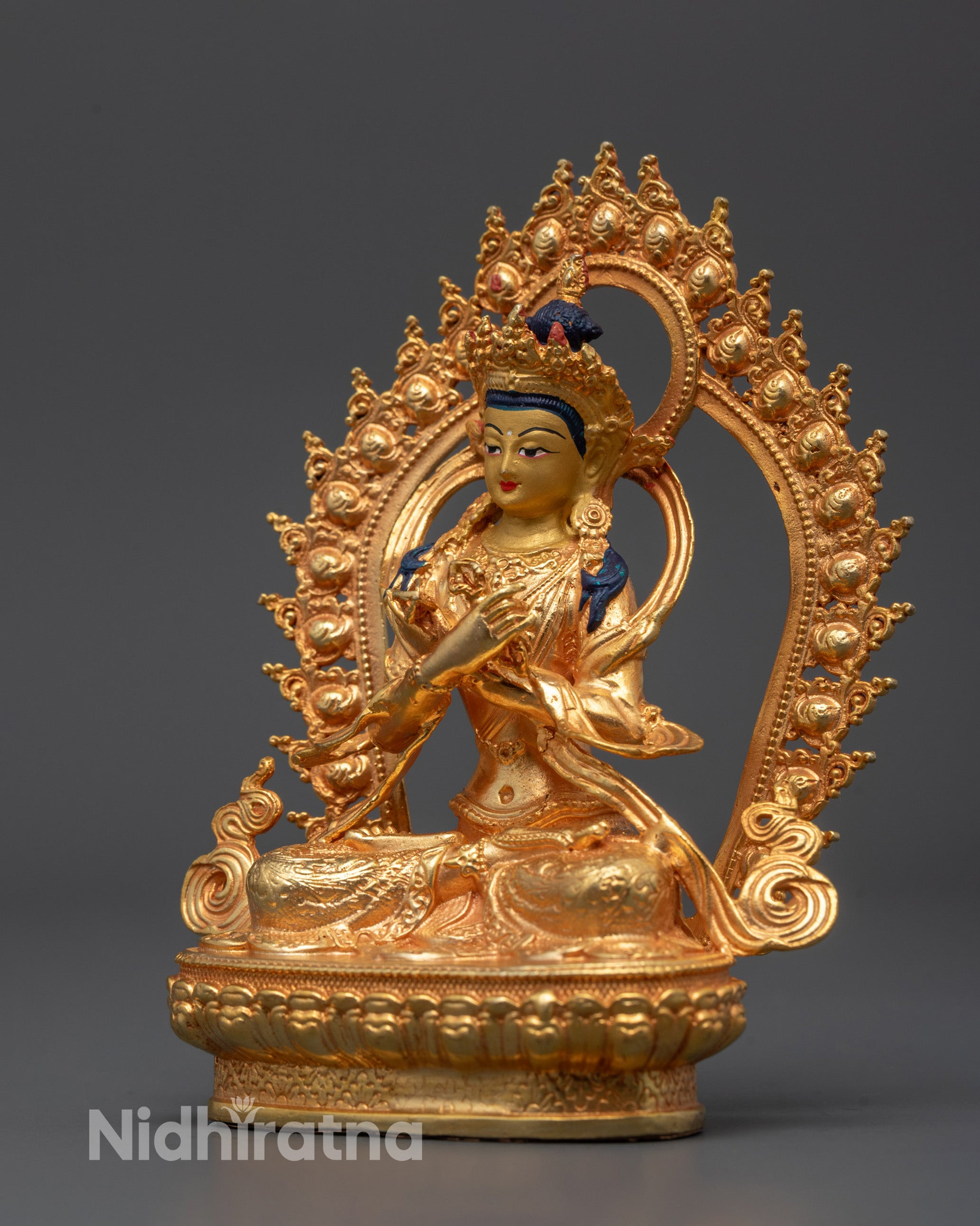 Detailed view of the radiant 24k gold coated face and intricate decorations