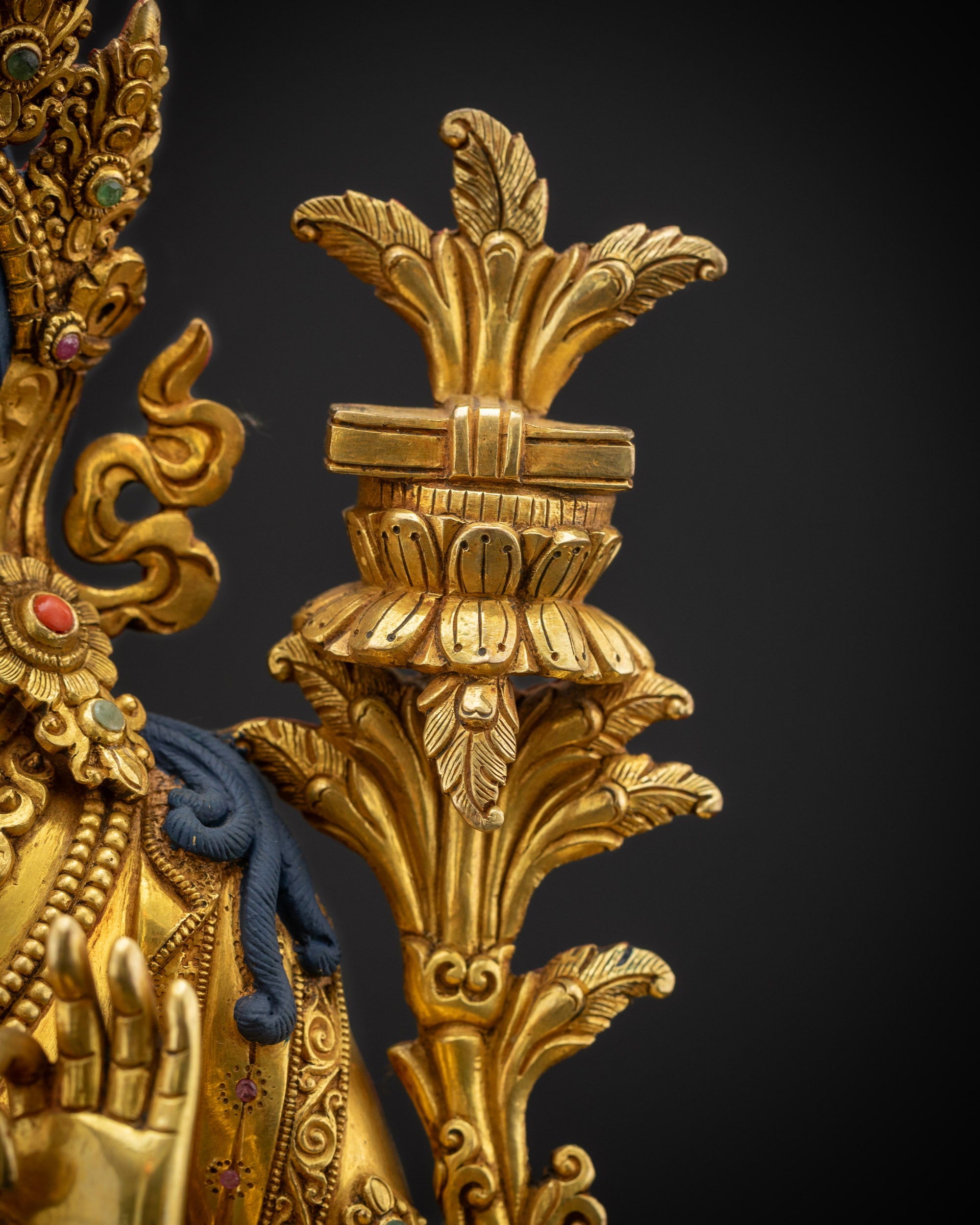 Detailed view of utpala flower topped with Prajna Paramita sutra held by Simhada Manjushri statue