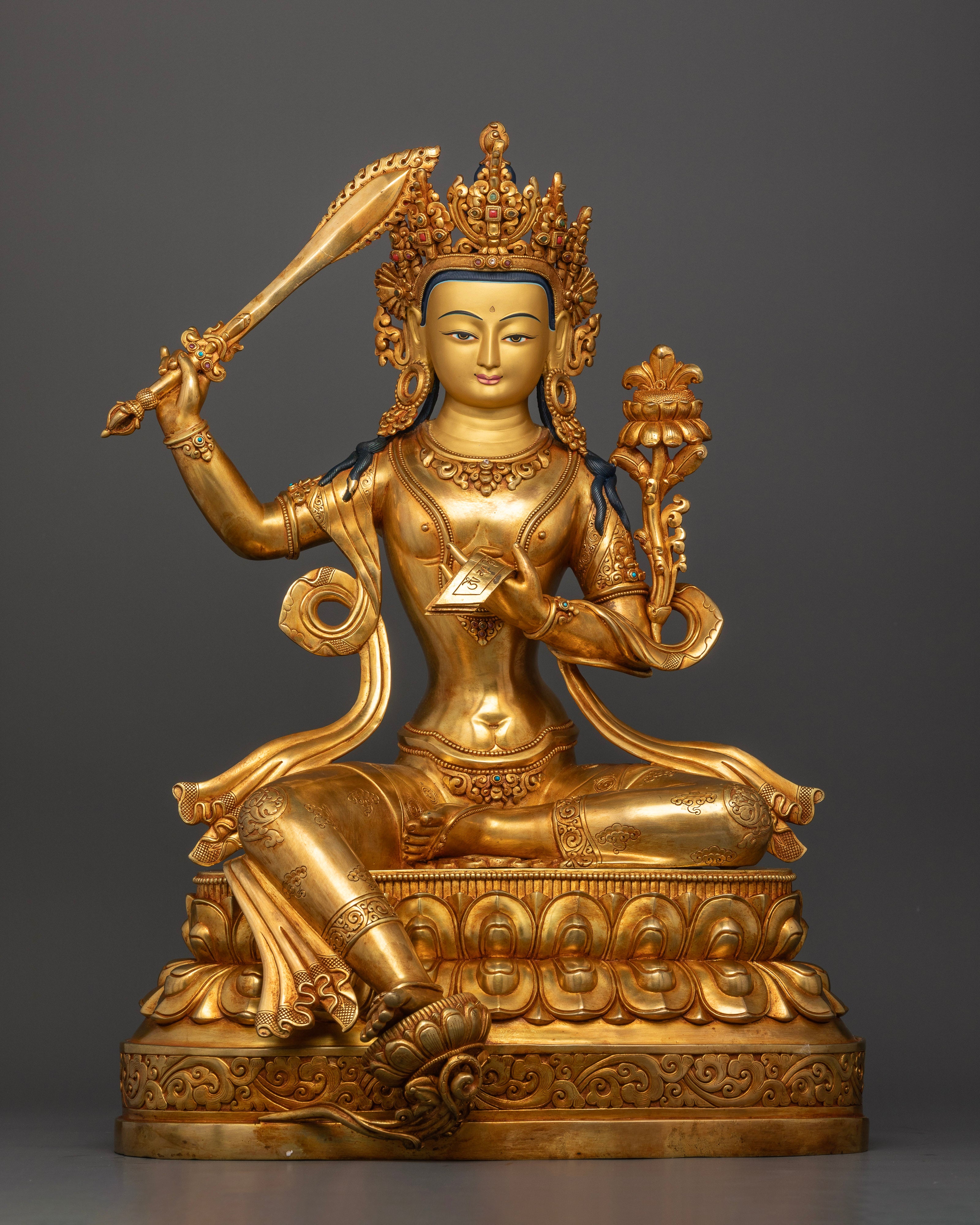 Divine Manjushri statue seated on double lotus throne with flaming wisdom sword