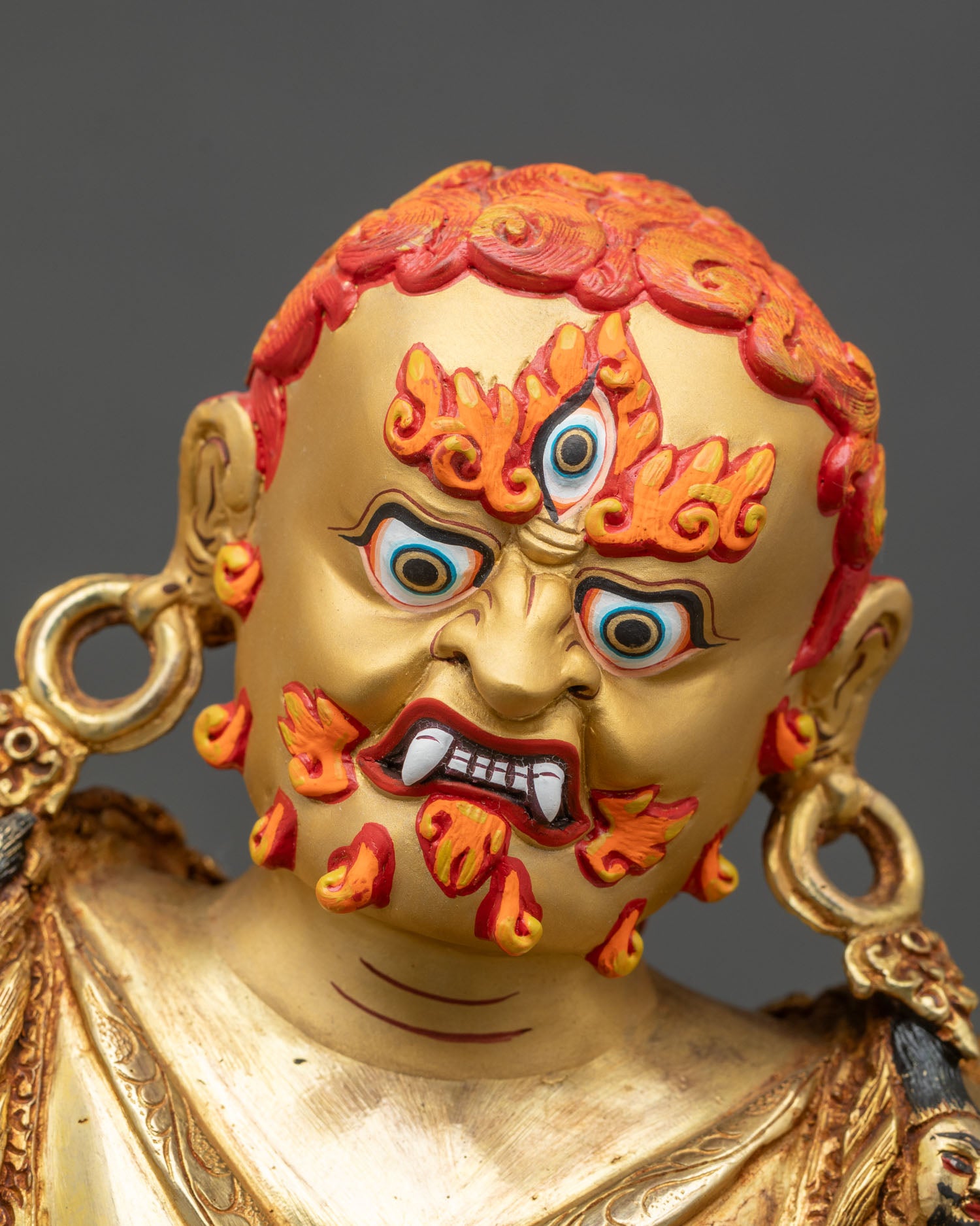Dorje Drolo statue showing intricate copper and gold details, sacred aura