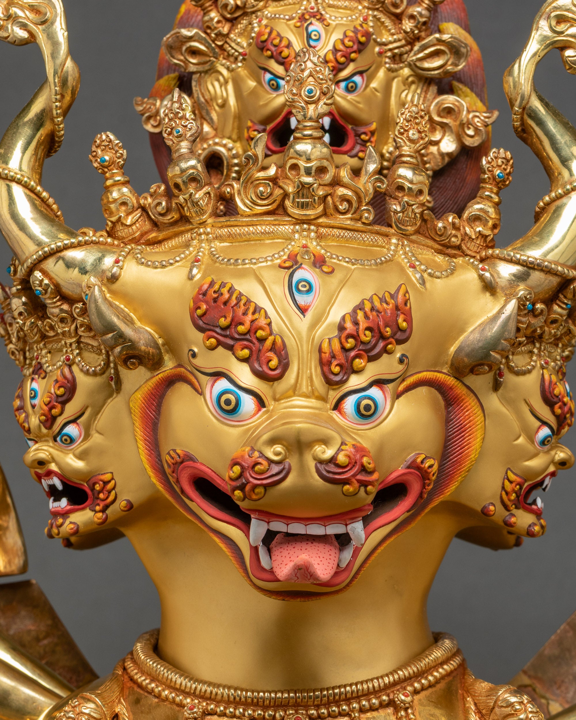 Close-up of Dorje Jigje Union Statue face with gold-painted wrathful expression