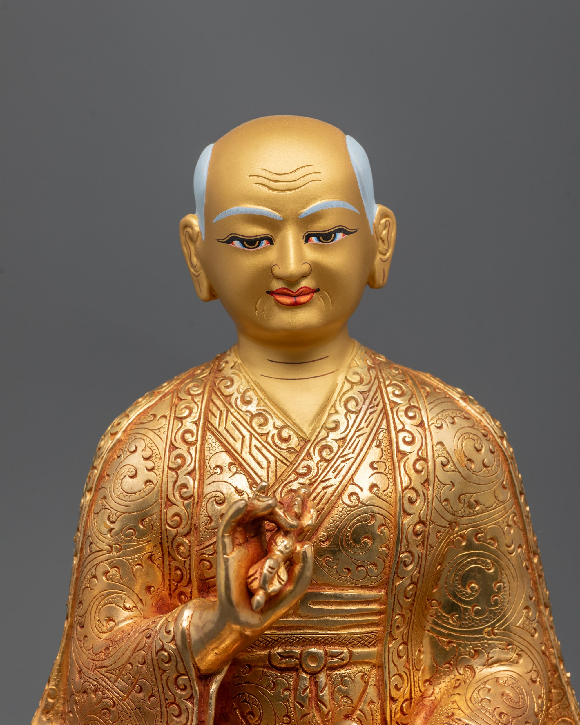 Drakpa Gyaltsen statue holding a vajra and bell for tantric balance.