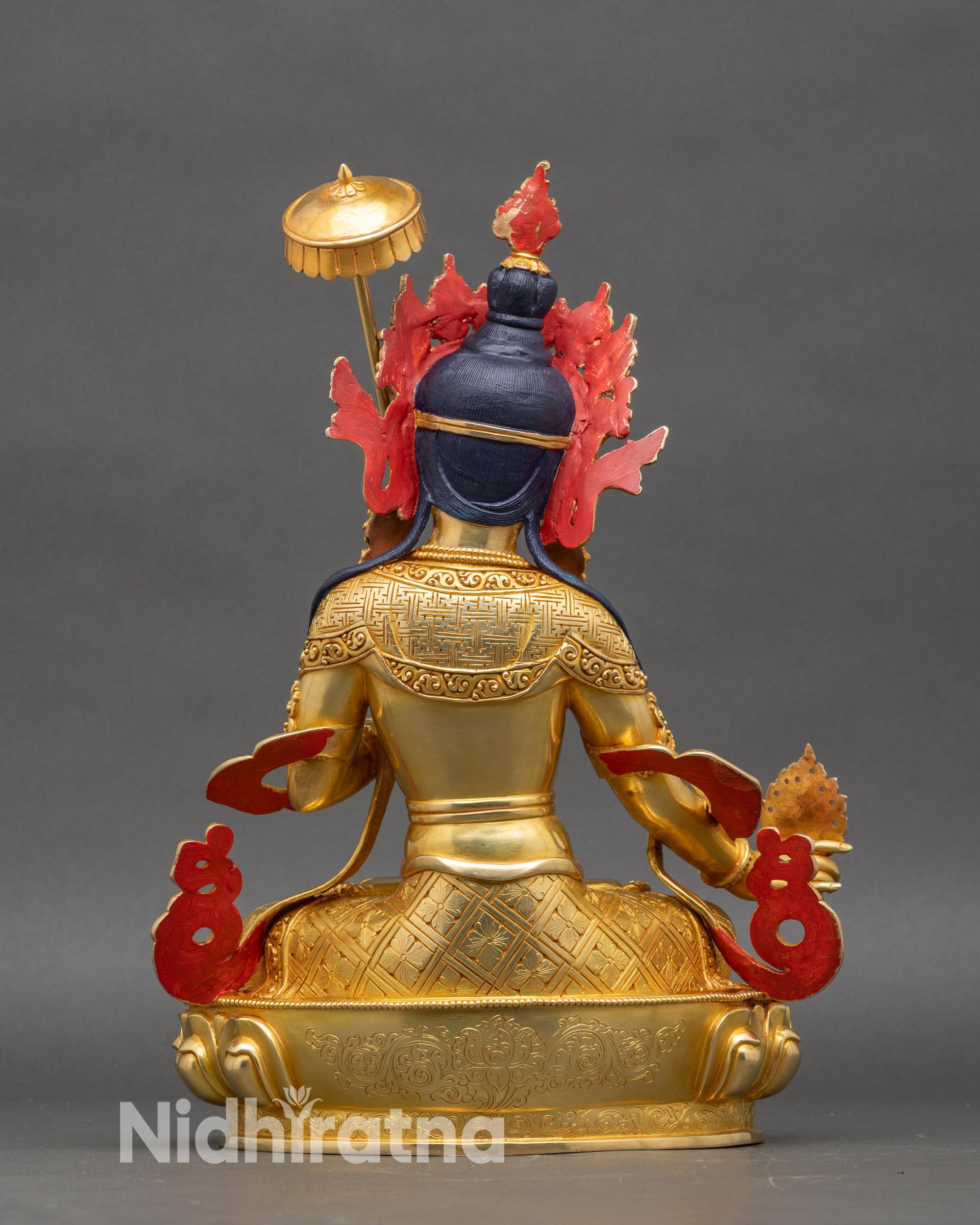 Dukar statue rear view, intricate copper detailing on lotus pedestal, gold finish