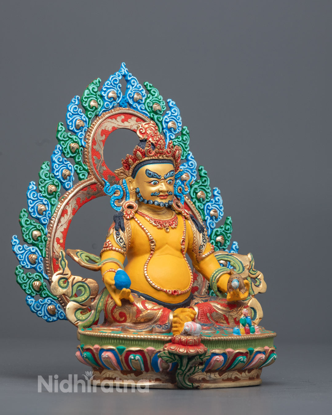 Dzambhala deity seated in royal ease posture on lotus throne holding citron fruit and jewel-spitting mongoose