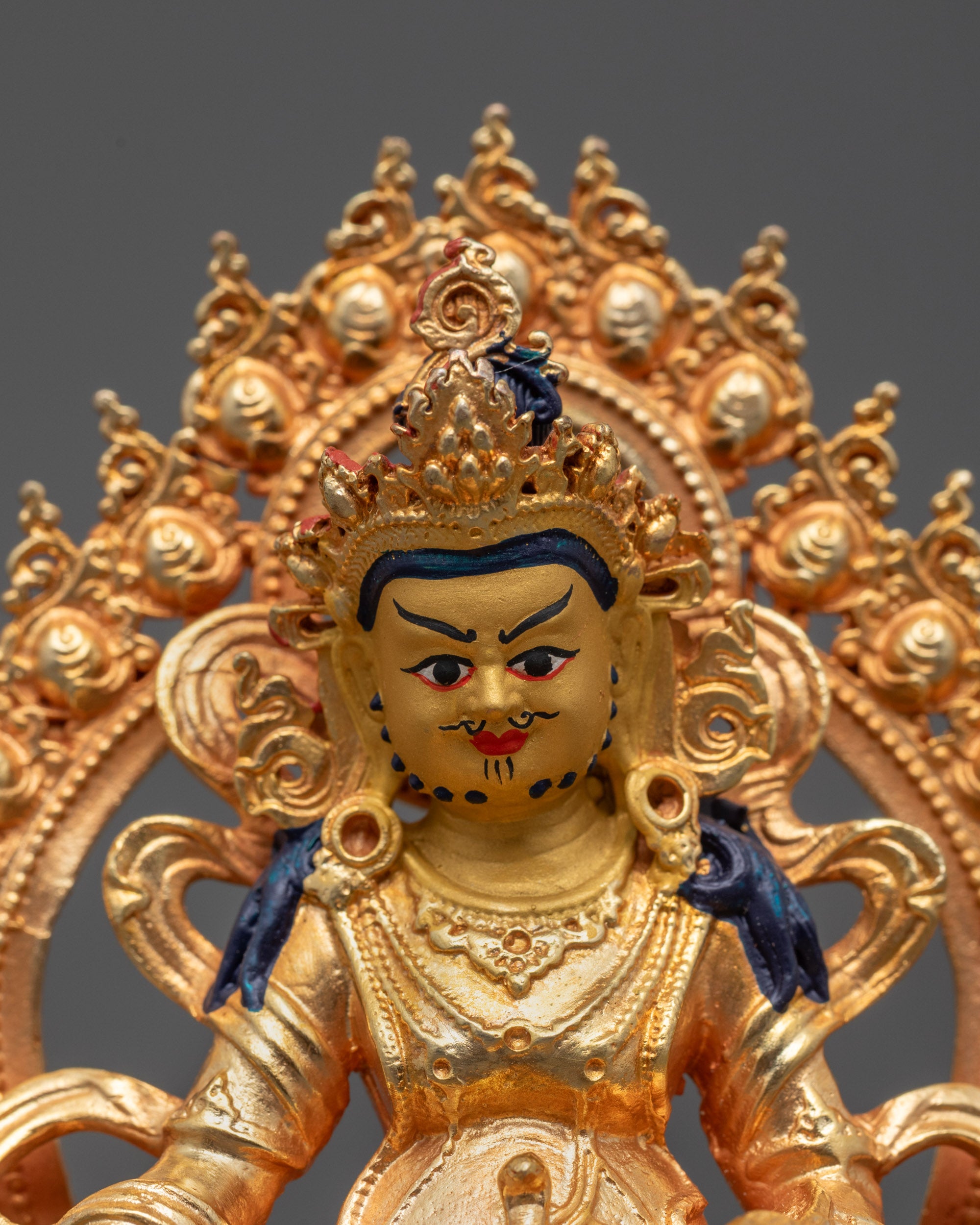 Close-up of Golden Dzambhala Statue Showing Intricate Details