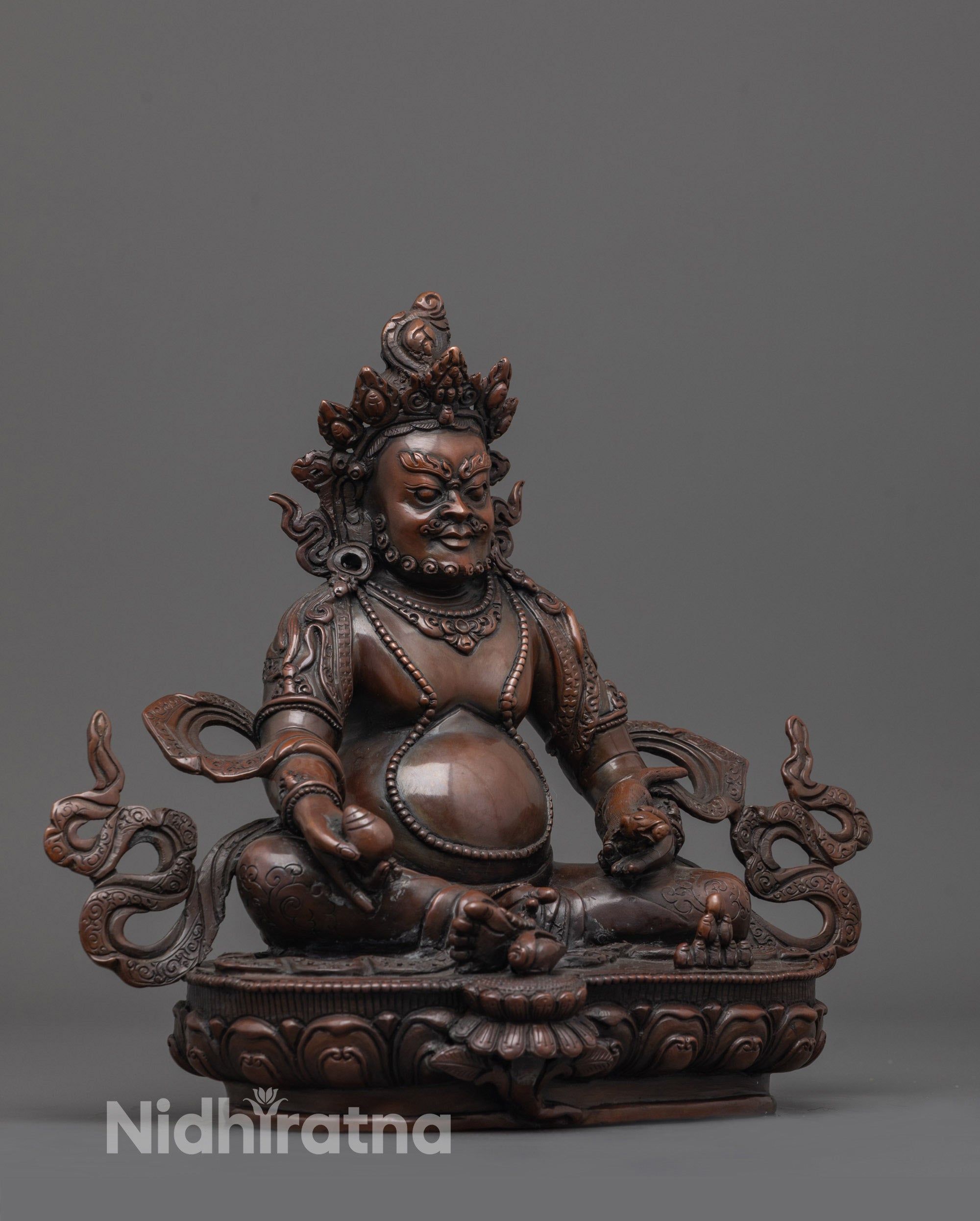 Side angle of Dzambhala statue showing sacred mongoose and citron fruit in hand