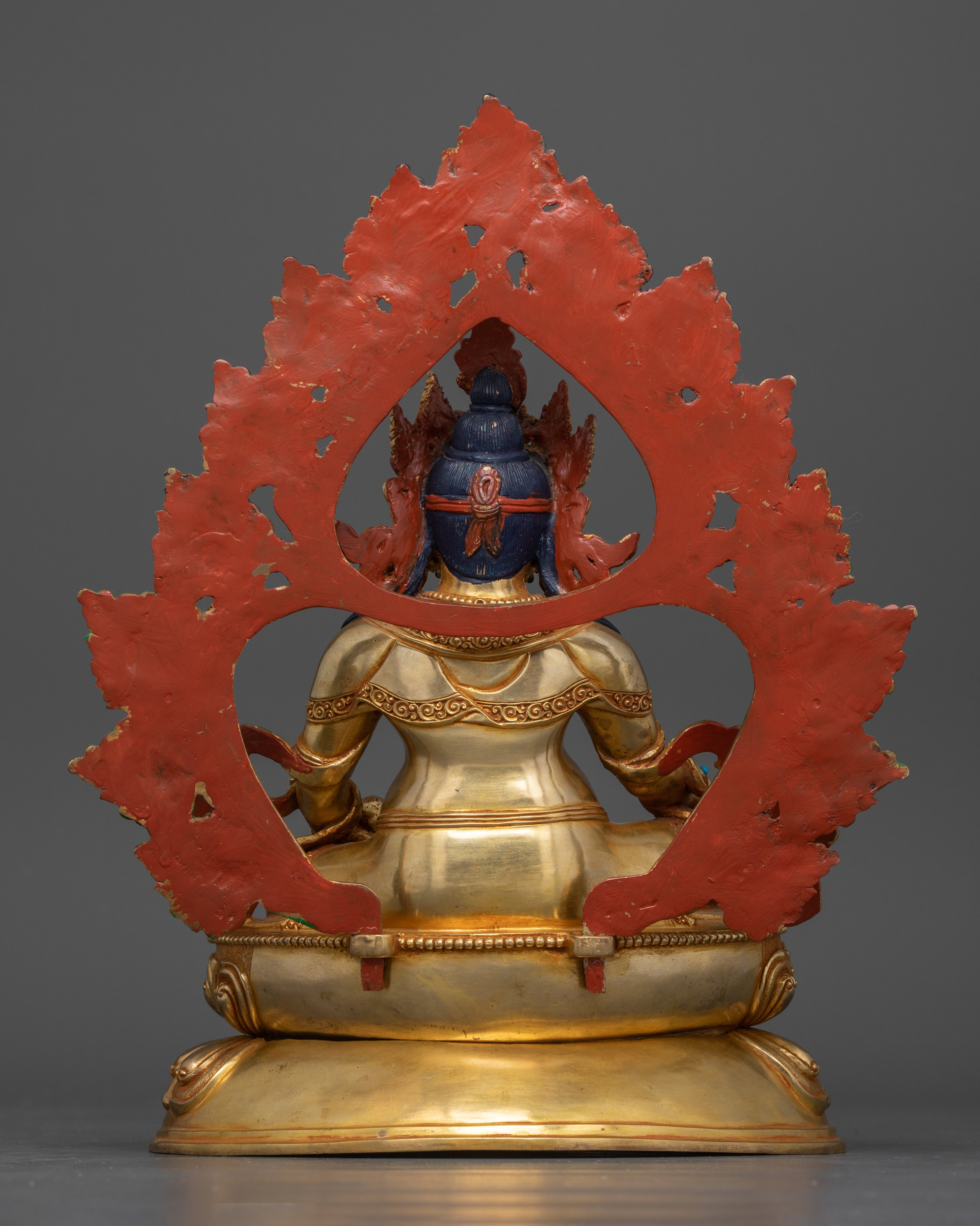 Back view showcasing the intricate detailing on the deity's robe, the halo, and the design of the lotus base.