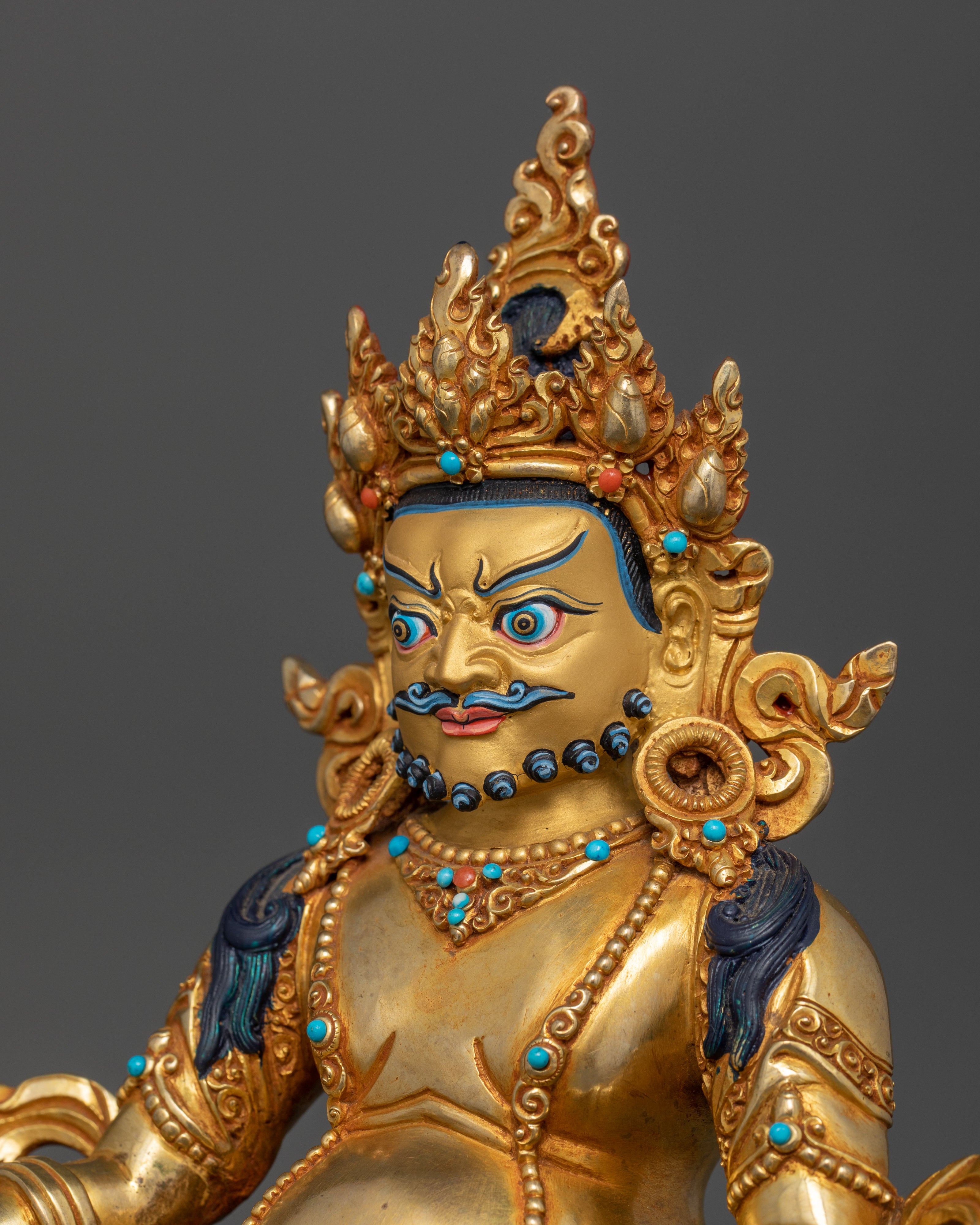 Portrait of Dzambhala’s left side, showcasing the intricate detailing on his expression, ornate adornments, and crown without a halo.