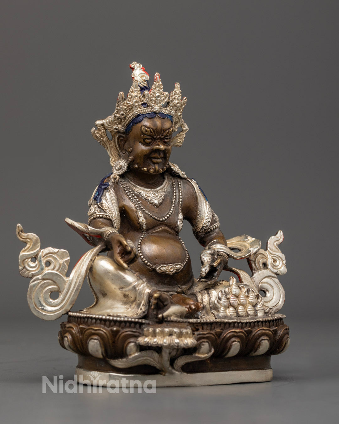 Dzambhala statue seated on a lion throne, showcasing spiritual union and abundance in Tibetan Buddhist craftsmanship.