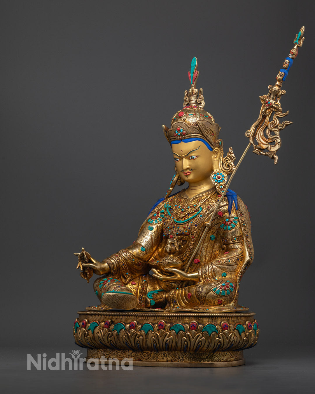 Exquisite Guru Rinpoche Statue adorned with semi-precious stones, showcasing detailed carvings on the crown, jewelry, and robes.