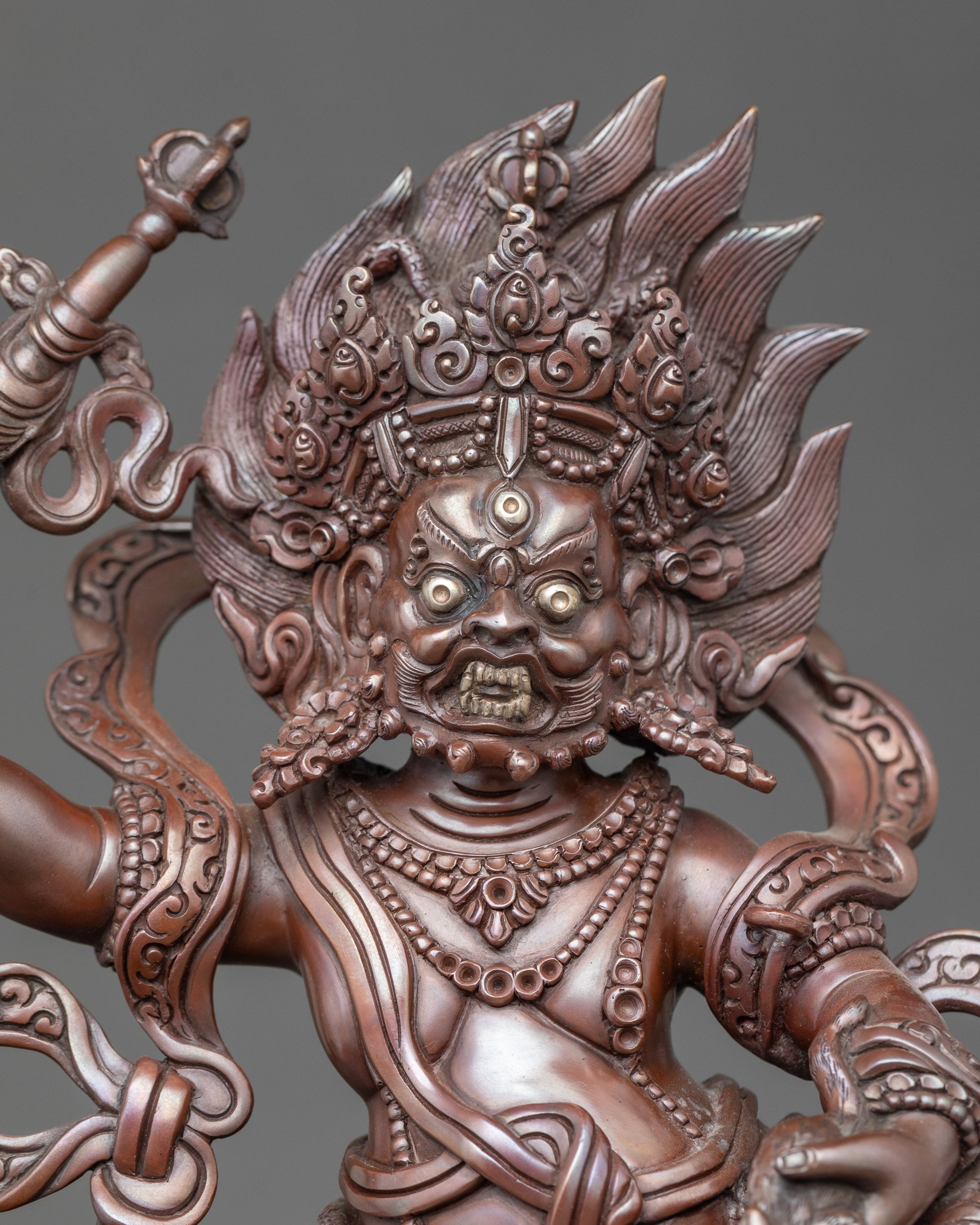 Close-up of White Dzambhala face, wrathful expression, fierce compassion, divine aura