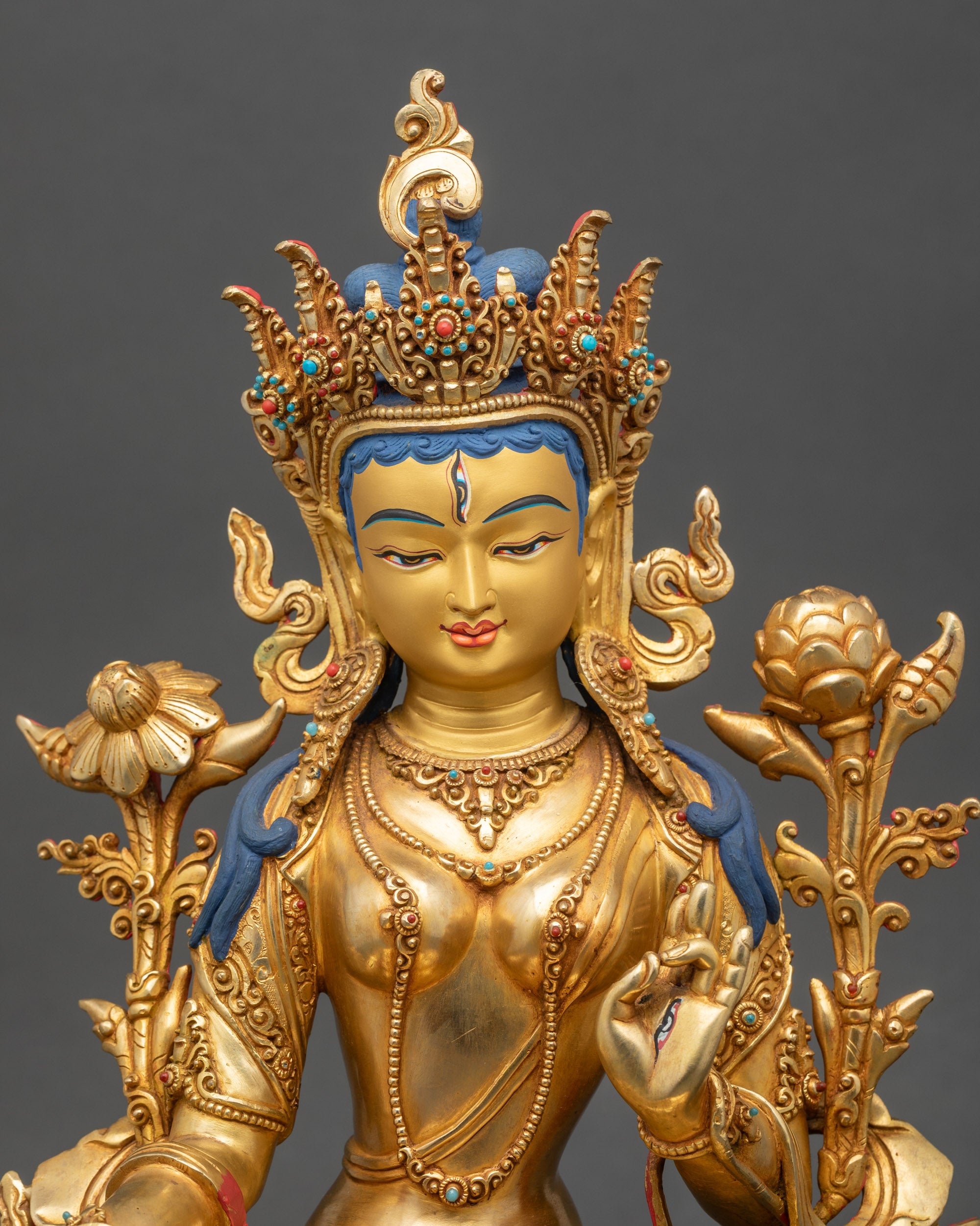 Close-up of White Tara Bodhisattva face, serene gold-painted features, Newari craftsmanship