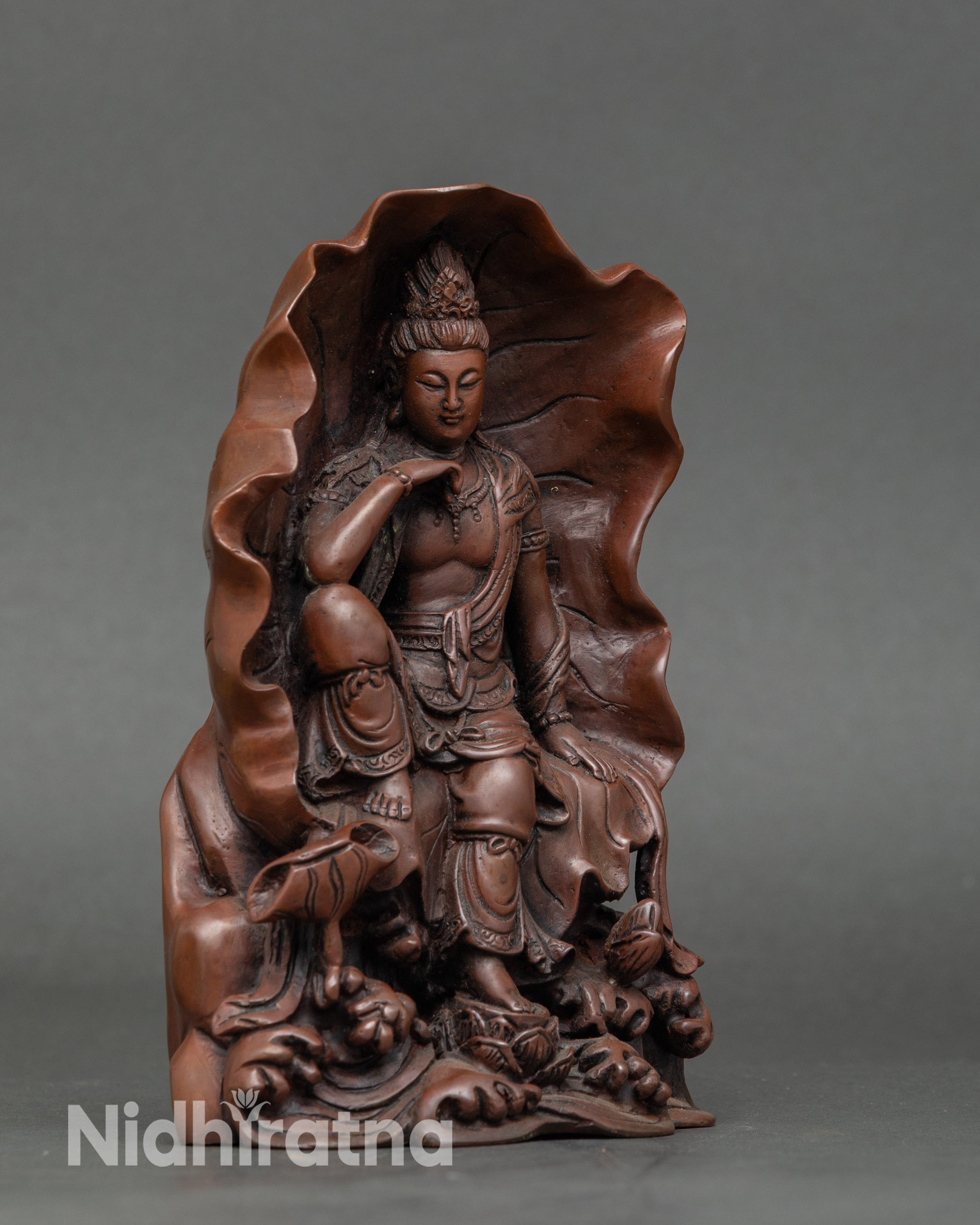 Close up Guan Yin serene face with flower bun oxidized copper sculpture