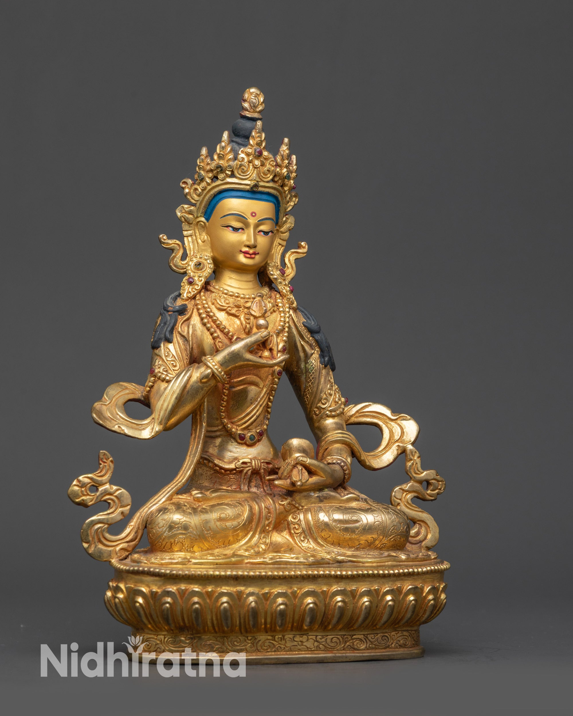 Side view of Nepalese Vajrasattva statue holding vajra and bell on lotus seat