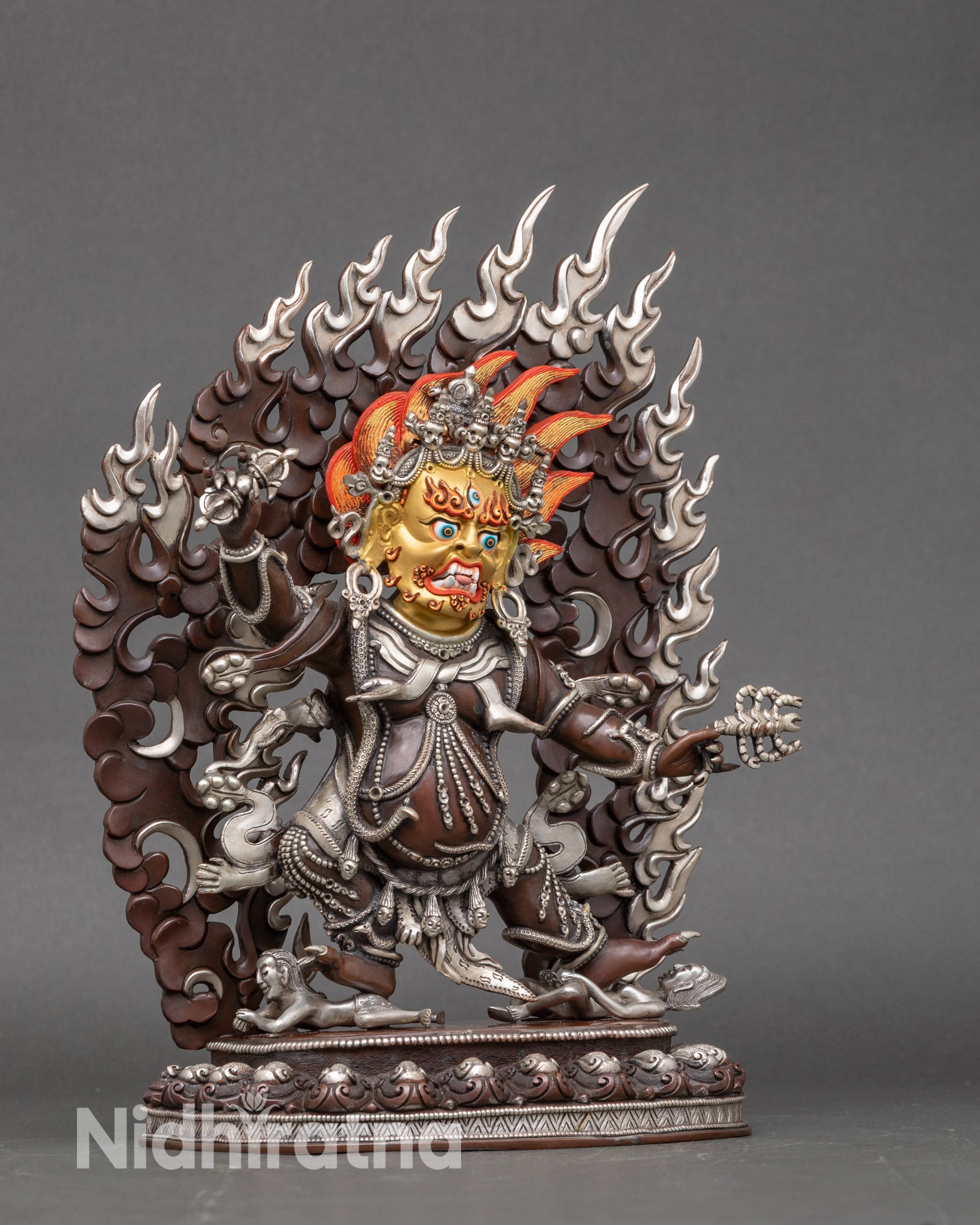 Side view of Himalayan Guru Drakpo statue subduing human figures, handcrafted by Newari artisan