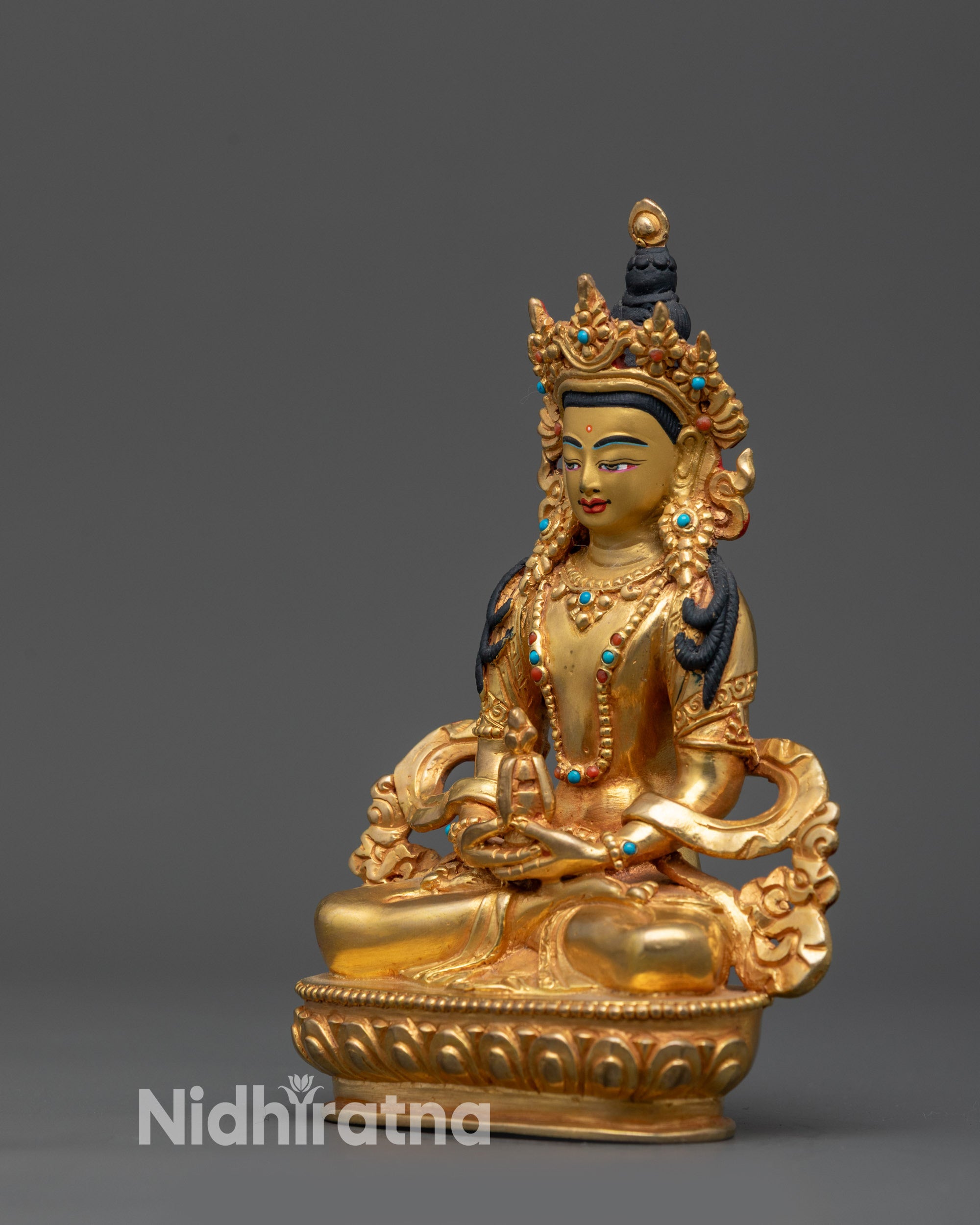 Back view of Amitayus statue with detailed robes and traditional lotus base