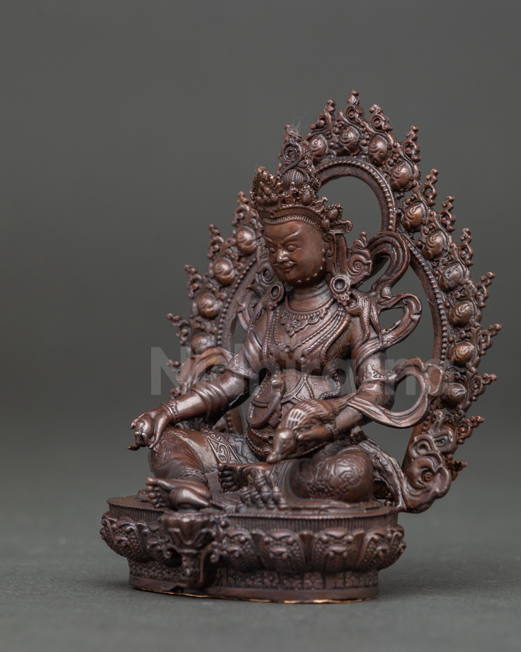 Detailed view of Dzambhala statue highlighting wealth symbols and Himalayan craftsmanship