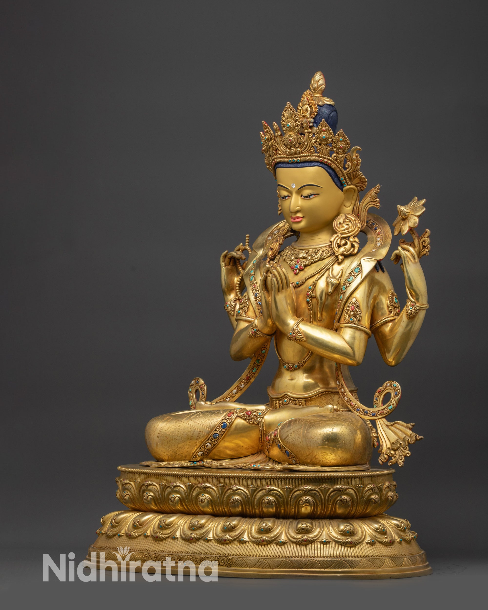 Left side view of Chenrezig Statue highlighting armlets and gold-gilded details