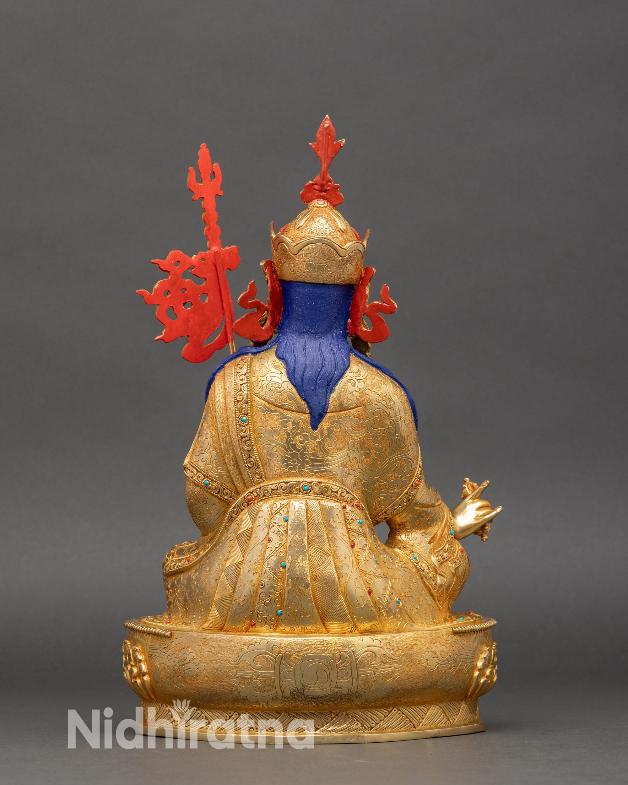 Back of Guru Rinpoche statue showing engraved robes and detailed lotus pedestal